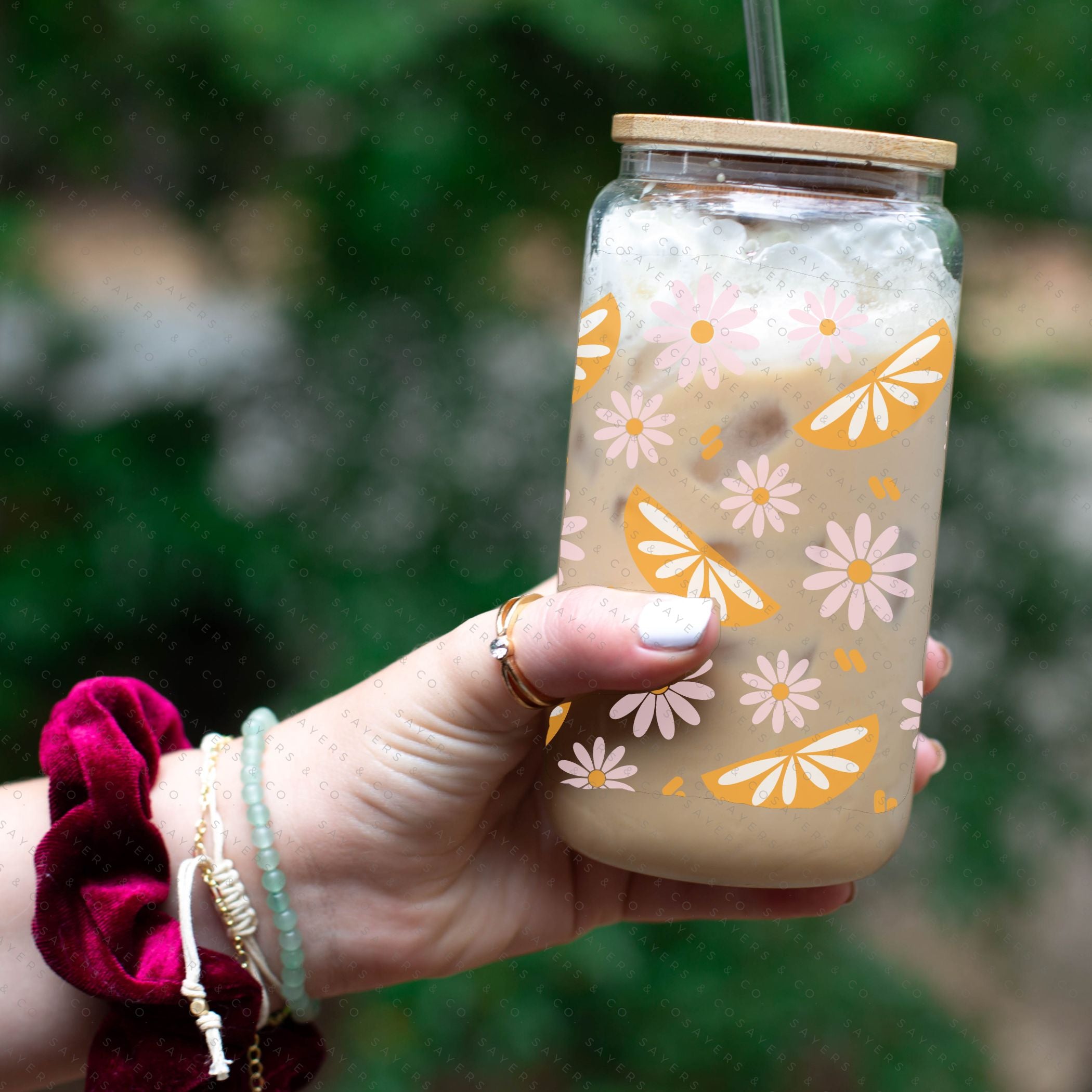 16oz Spring Squeeze The Day Glass Cup with bamboo lid and straw, showcasing a vibrant floral design perfect for spring.
