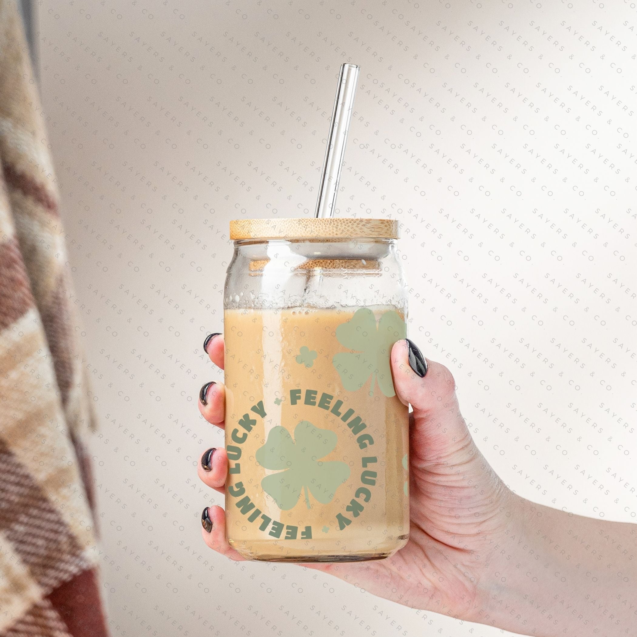 16oz St. Patrick's Day Feeling Lucky Shamrock Glass Cup featuring a bamboo lid and straw, perfect for festive drinks.