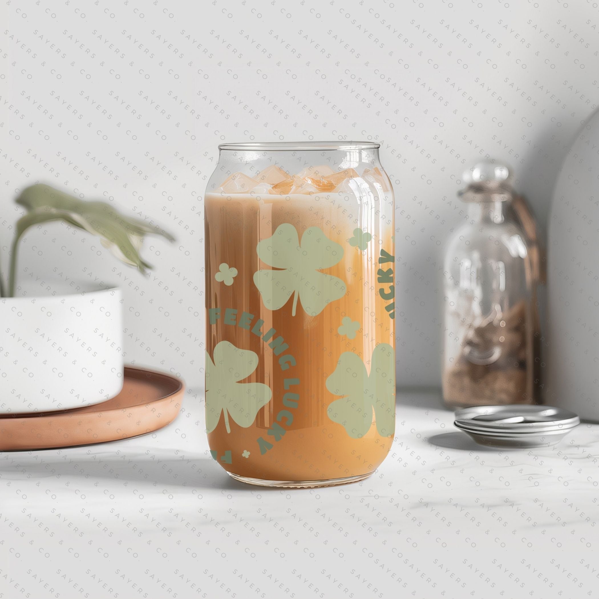 16oz St. Patrick's Day Feeling Lucky Shamrock Glass Cup featuring a bamboo lid and straw, perfect for festive drinks.