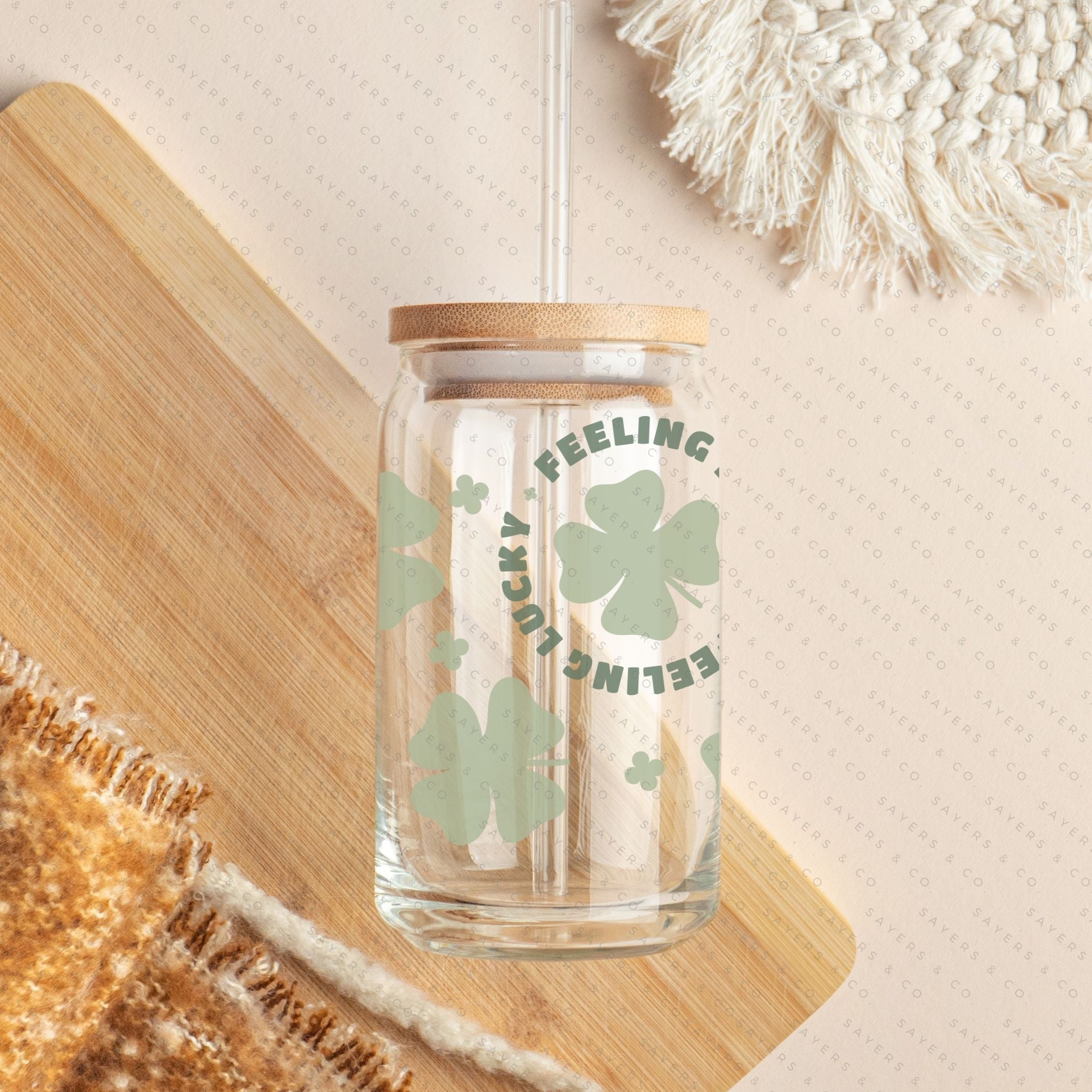 16oz St. Patrick's Day Feeling Lucky Shamrock Glass Cup featuring a bamboo lid and straw, perfect for festive drinks.