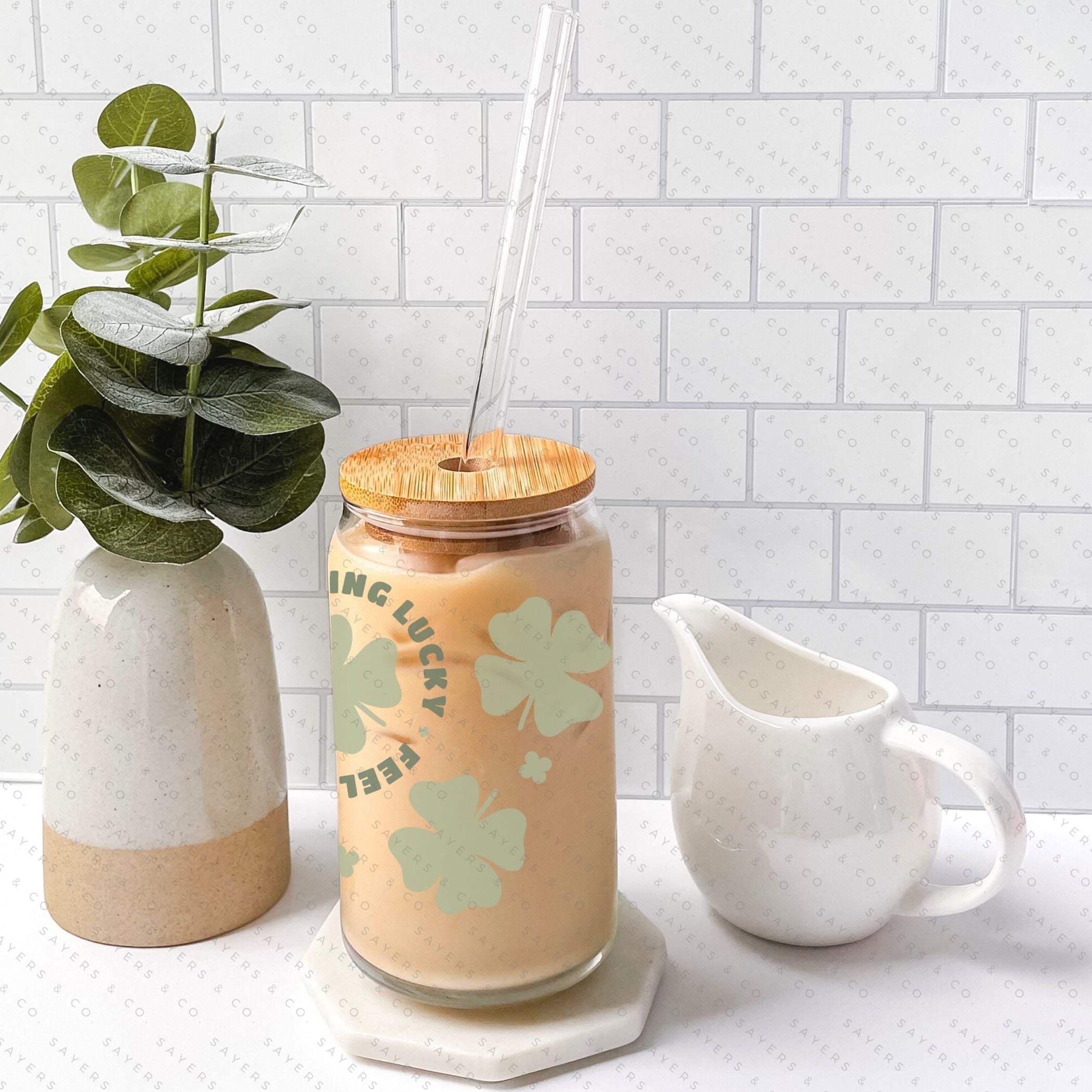 16oz St. Patrick's Day Feeling Lucky Shamrock Glass Cup featuring a bamboo lid and straw, perfect for festive drinks.