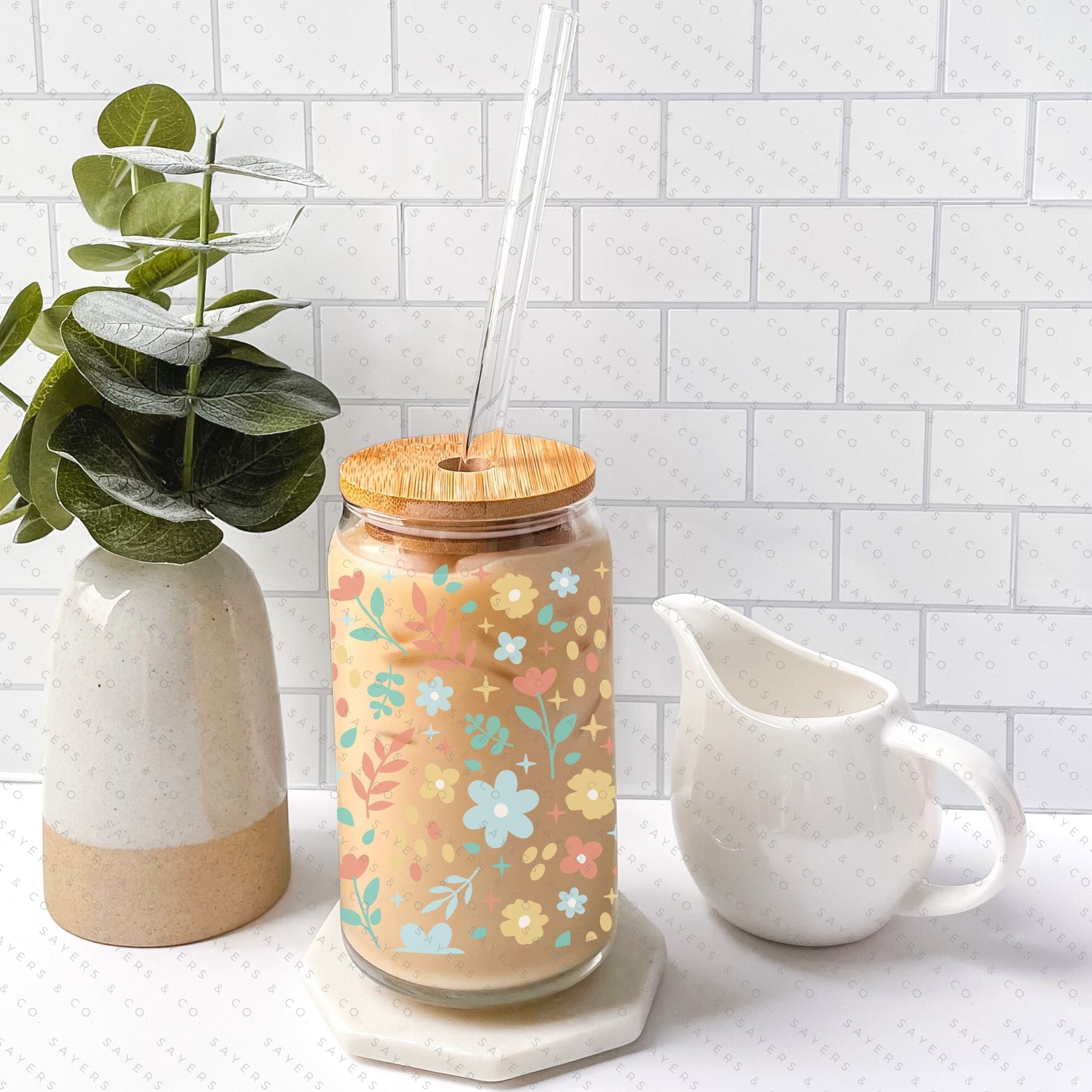 16oz Sweet Spring Glass Cup featuring a bamboo lid and straw, adorned with a floral design, perfect for beverages.