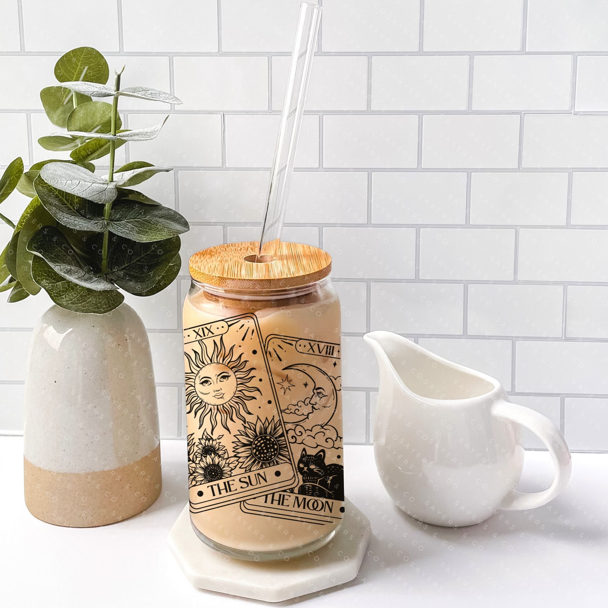 16oz Tarot Cards Sun and Moon Glass Cup featuring a bamboo lid and straw, perfect for various beverages.