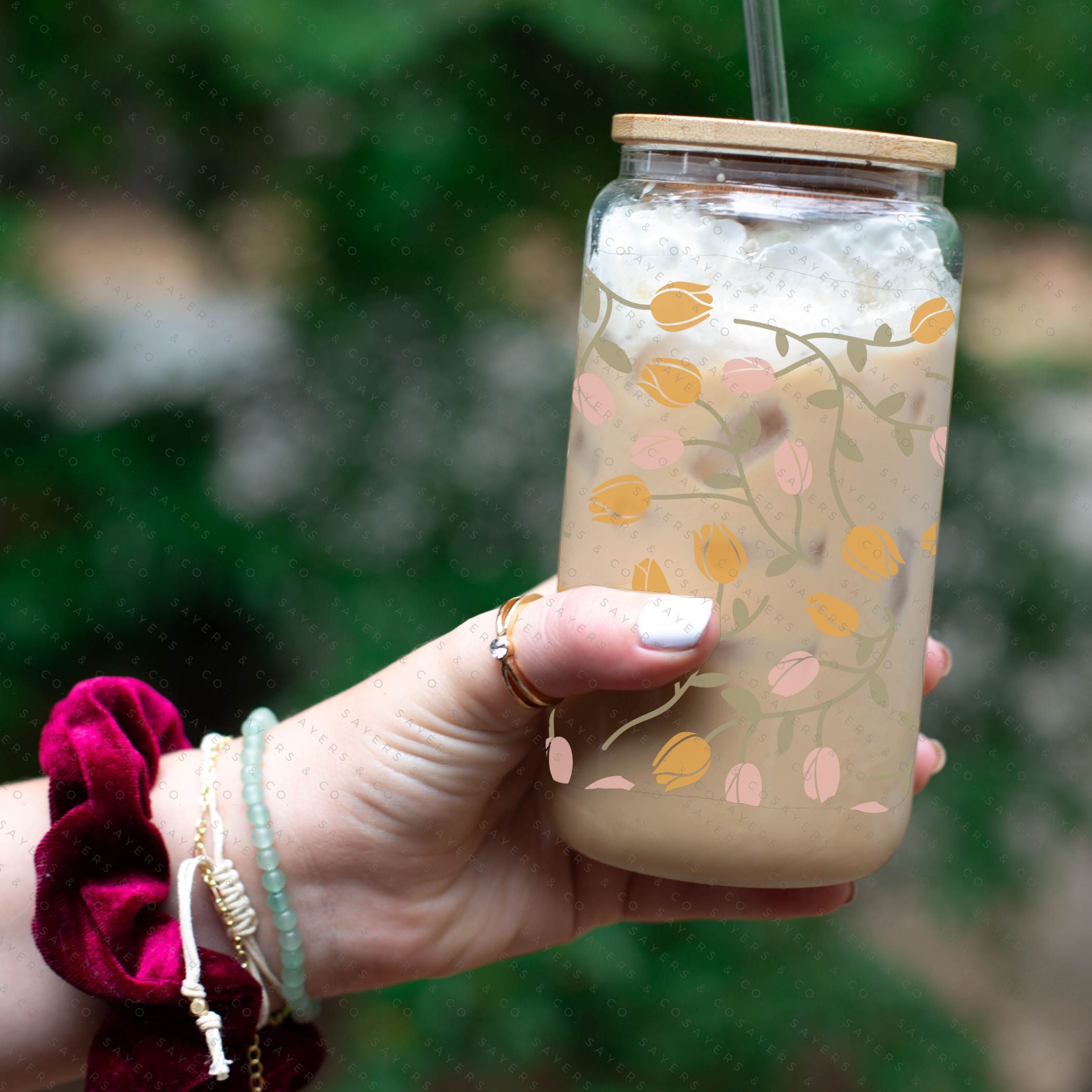 16oz Tulip Entanglement Glass Cup with bamboo lid and straw, featuring a floral design, perfect for beverages.