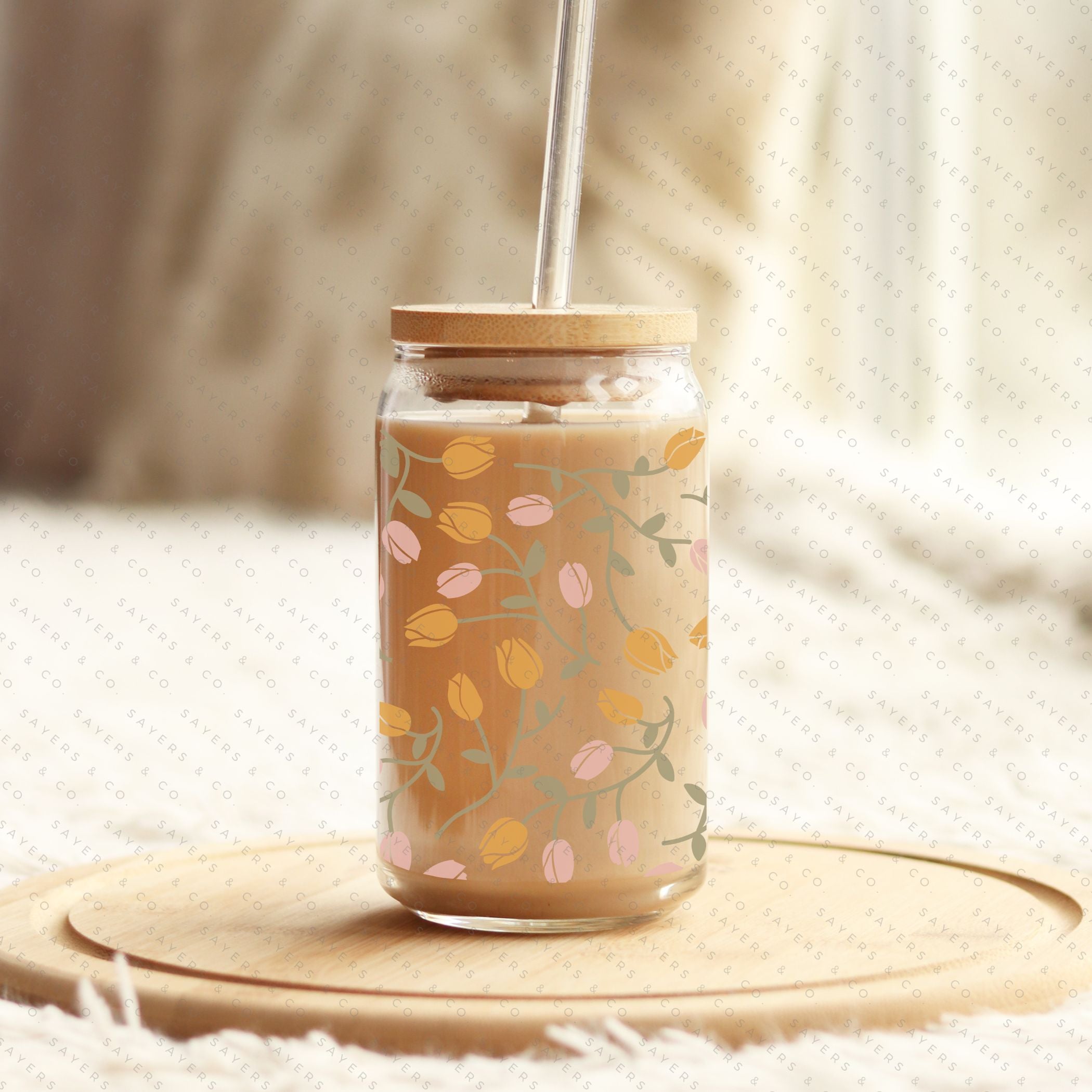 16oz Tulip Entanglement Glass Cup with bamboo lid and straw, featuring a floral design, perfect for beverages.