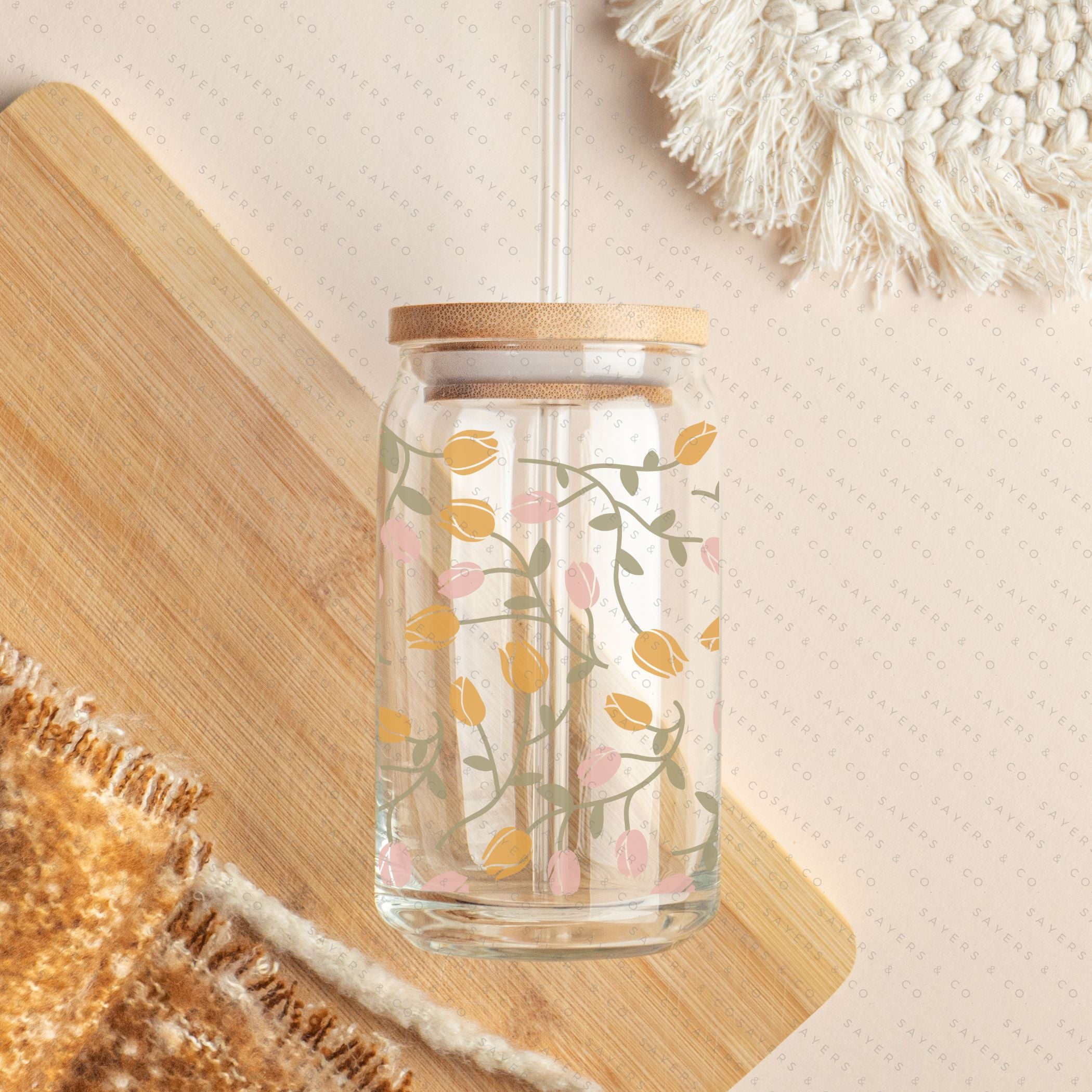 16oz Tulip Entanglement Glass Cup with bamboo lid and straw, featuring a floral design, perfect for beverages.