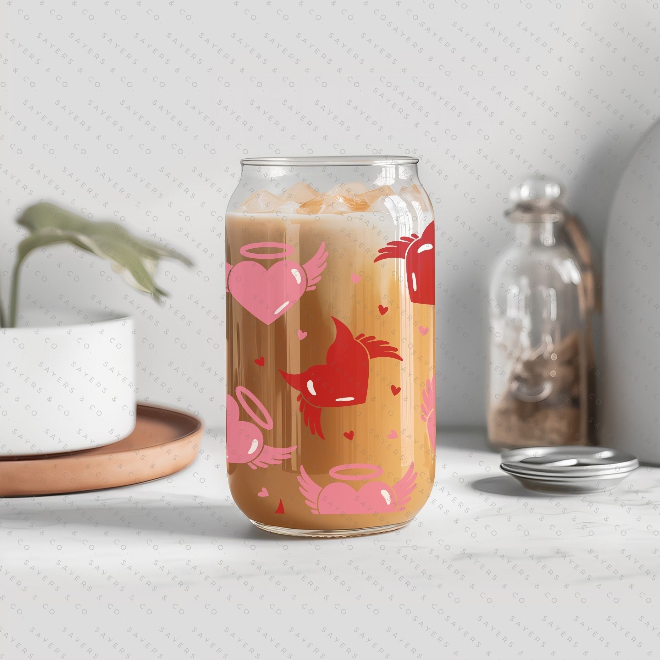 16oz Valentine's Day glass cup featuring angel and devil hearts design, with bamboo lid and clear straw, perfect for beverages.