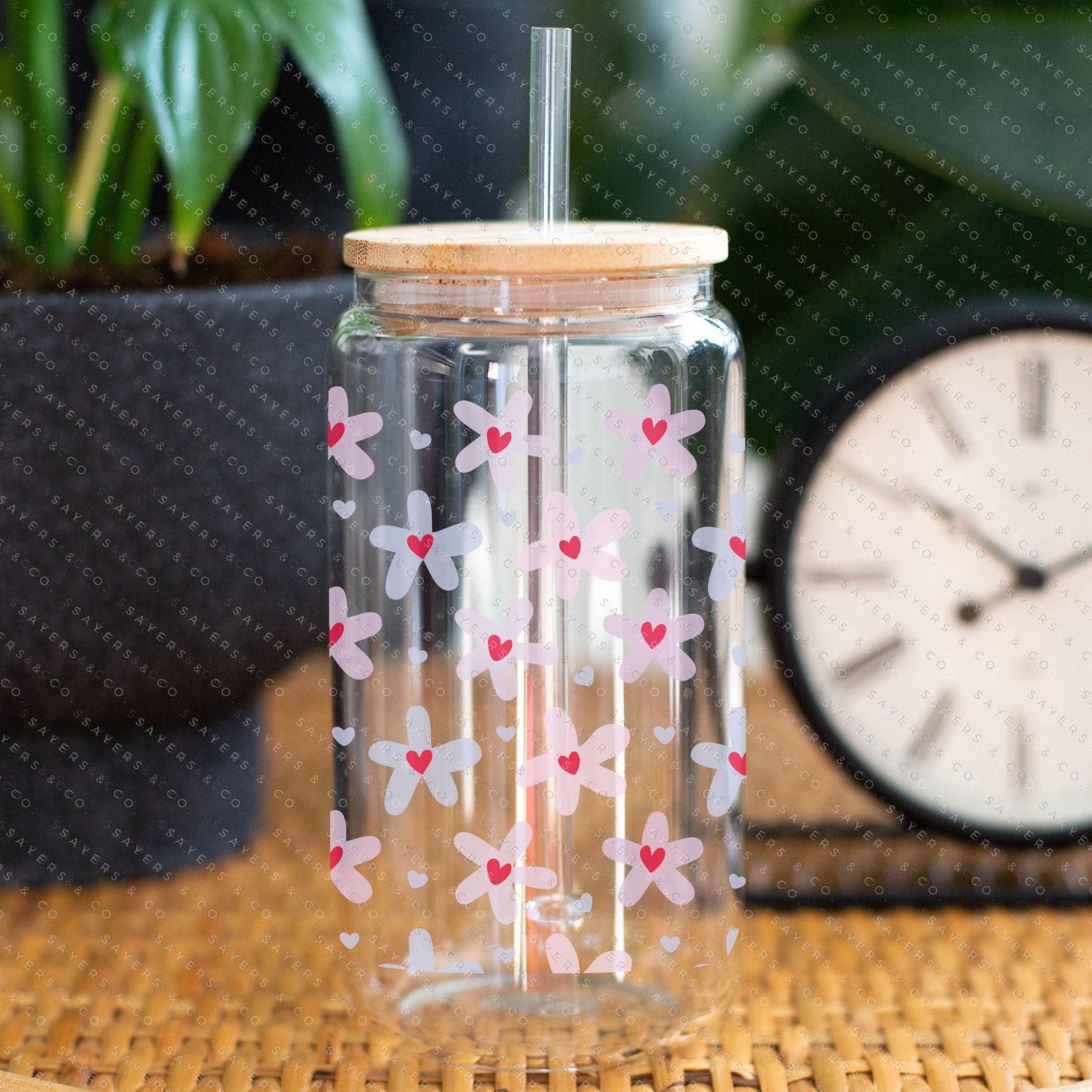 16oz Valentine's Day Daisy Hearts Glass Cup featuring a bamboo lid and straw, showcasing a floral design perfect for gifting.