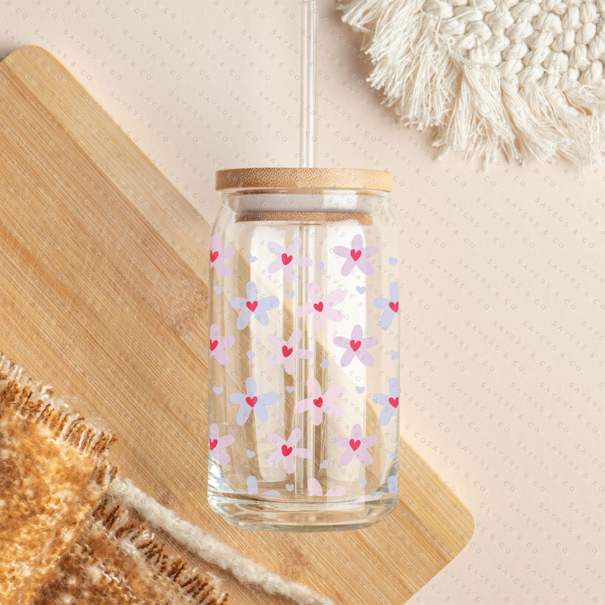 16oz Valentine's Day Daisy Hearts Glass Cup featuring a bamboo lid and straw, showcasing a floral design perfect for gifting.
