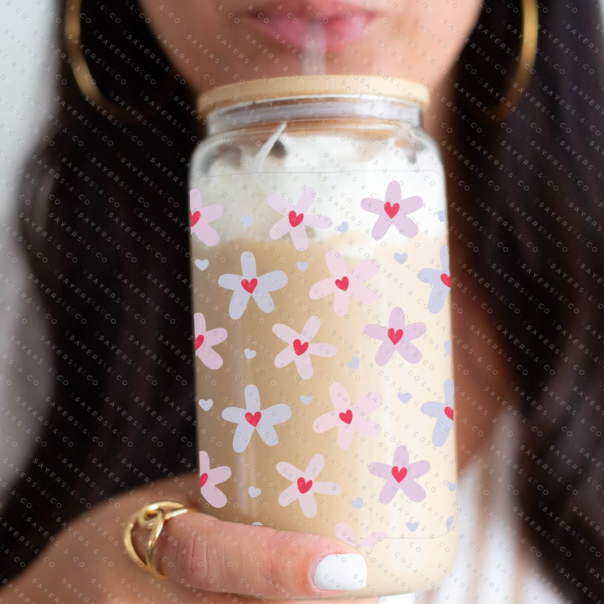 16oz Valentine's Day Daisy Hearts Glass Cup featuring a bamboo lid and straw, showcasing a floral design perfect for gifting.