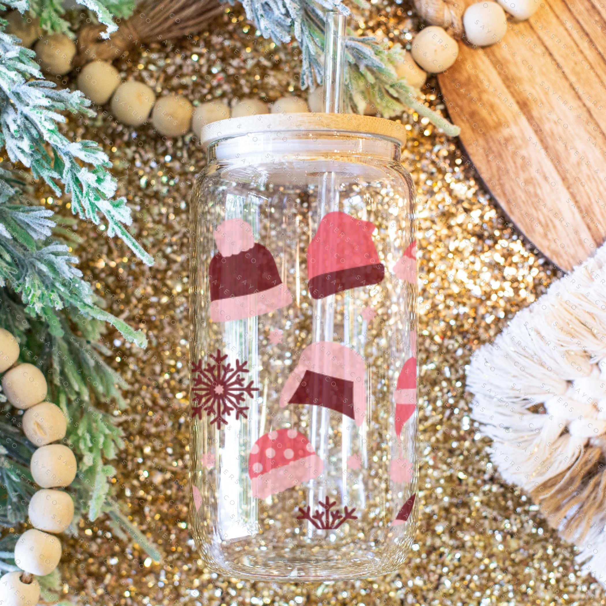 16oz Winter Beanies Glass Cup with bamboo lid and straw, featuring a festive winter design, perfect for holiday drinks.