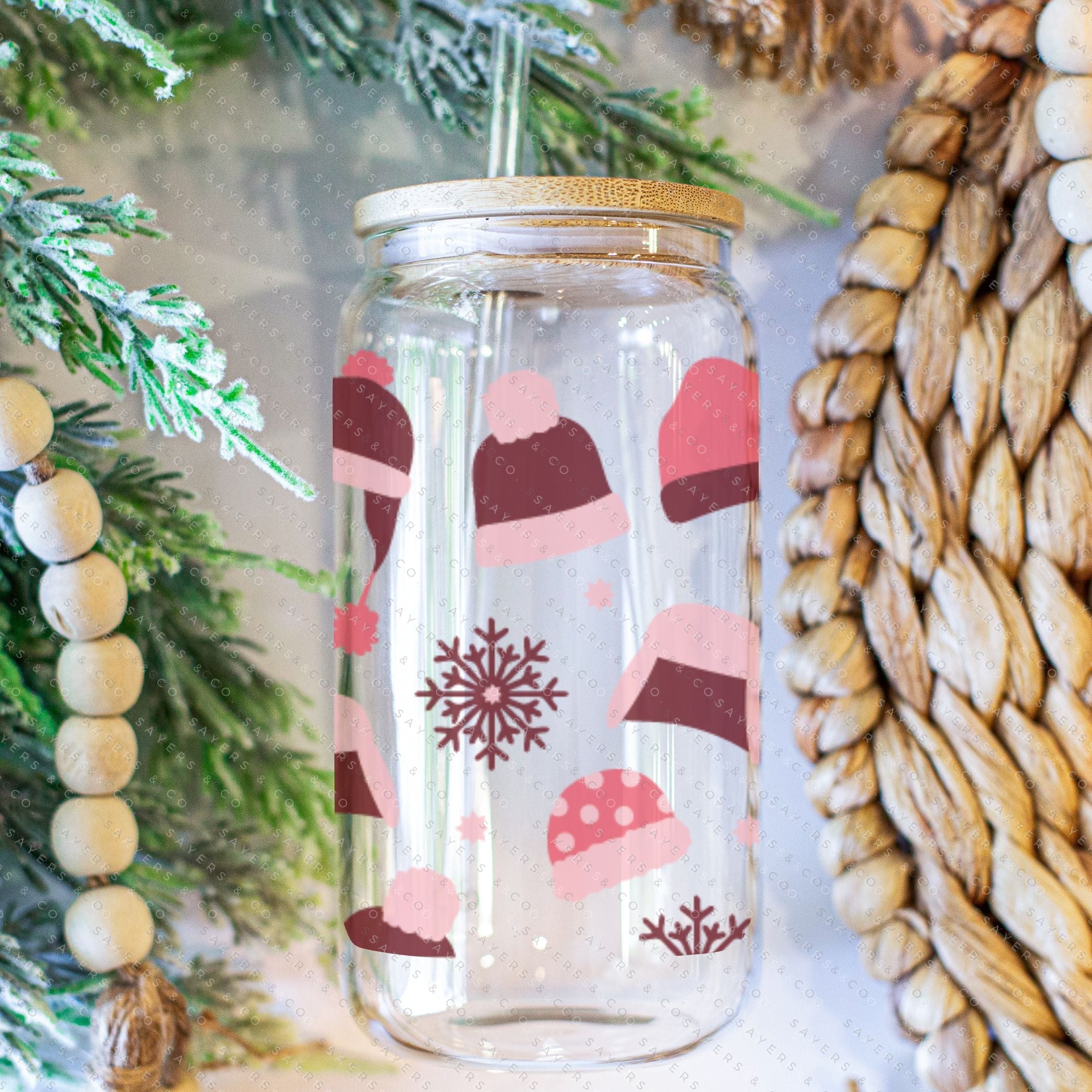 16oz Winter Beanies Glass Cup with bamboo lid and straw, featuring a festive winter design, perfect for holiday drinks.