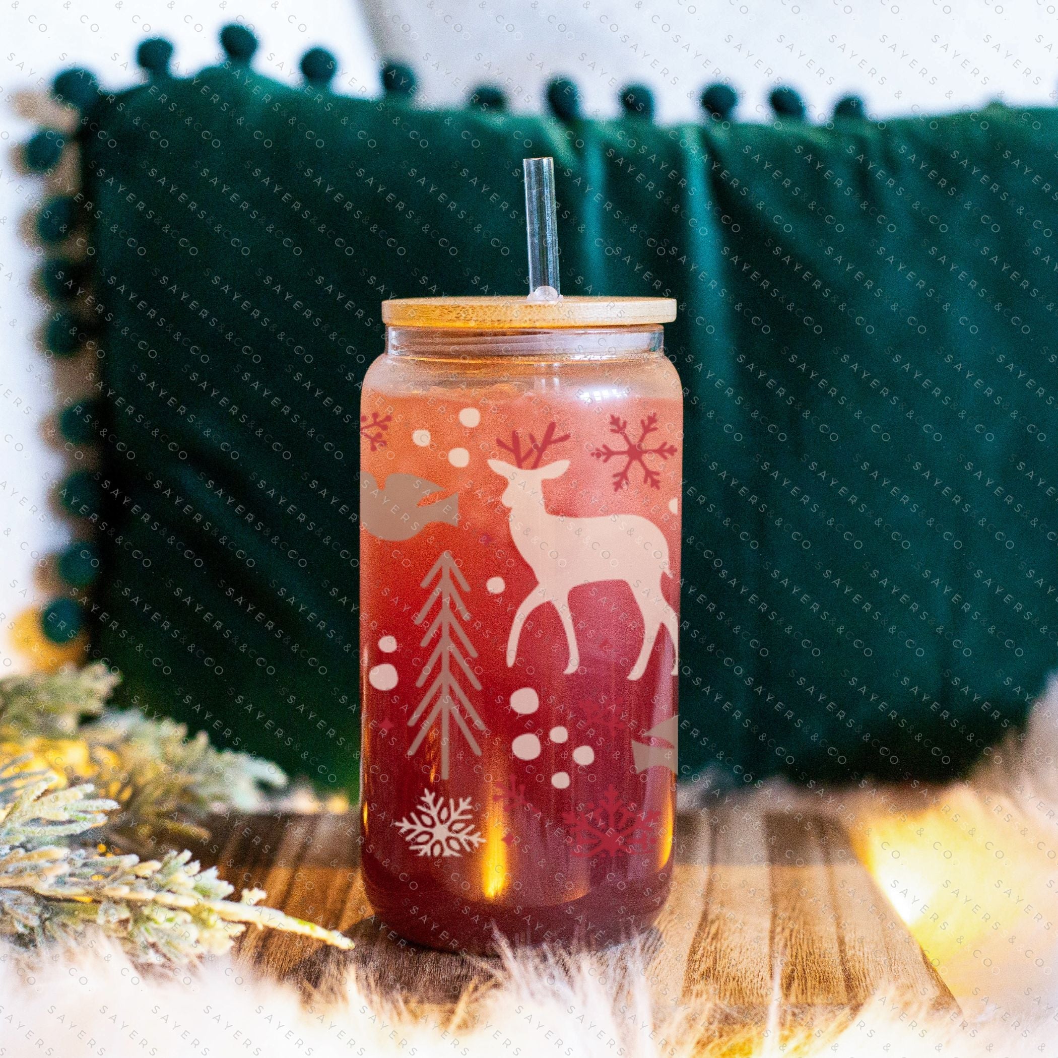 16oz Winter Magic Glass Cup with Bamboo Lid and Straw, featuring winter-themed designs and a clear glass finish.