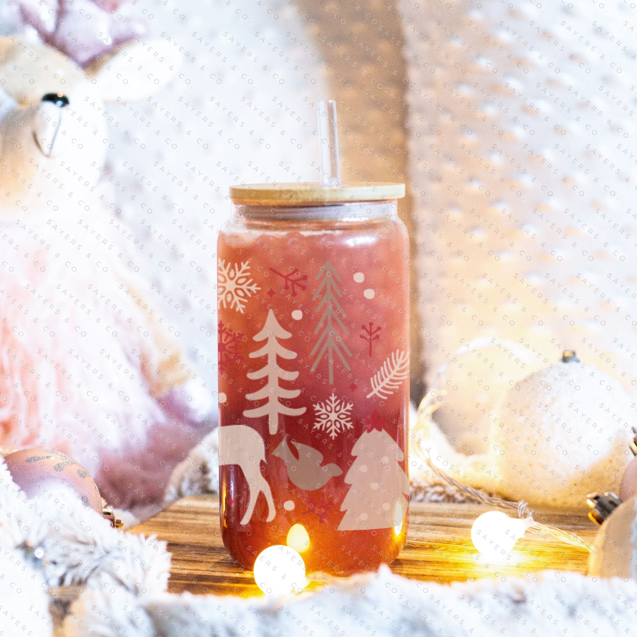 16oz Winter Magic Glass Cup with Bamboo Lid and Straw, featuring winter-themed designs and a clear glass finish.