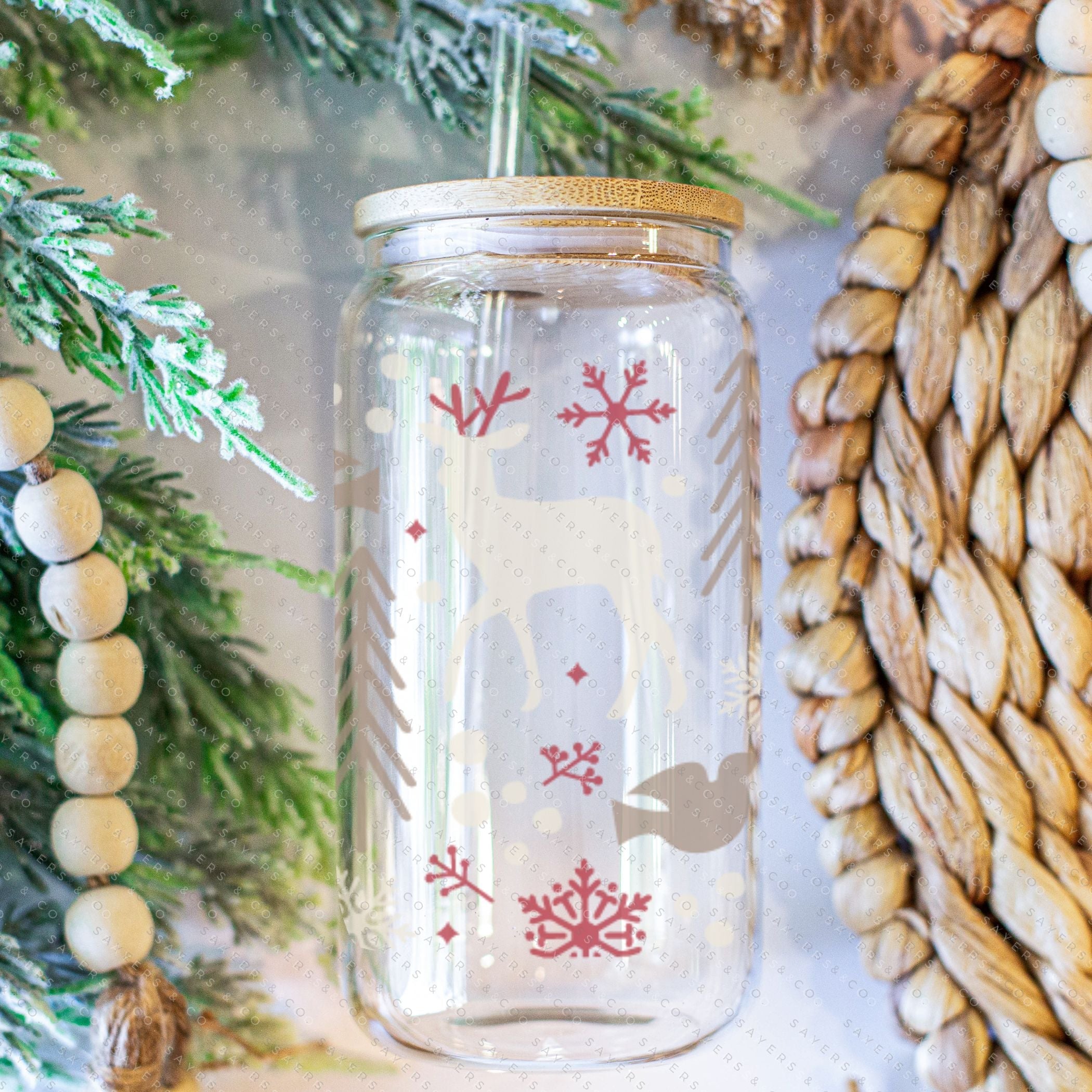 16oz Winter Magic Glass Cup with Bamboo Lid and Straw, featuring winter-themed designs and a clear glass finish.