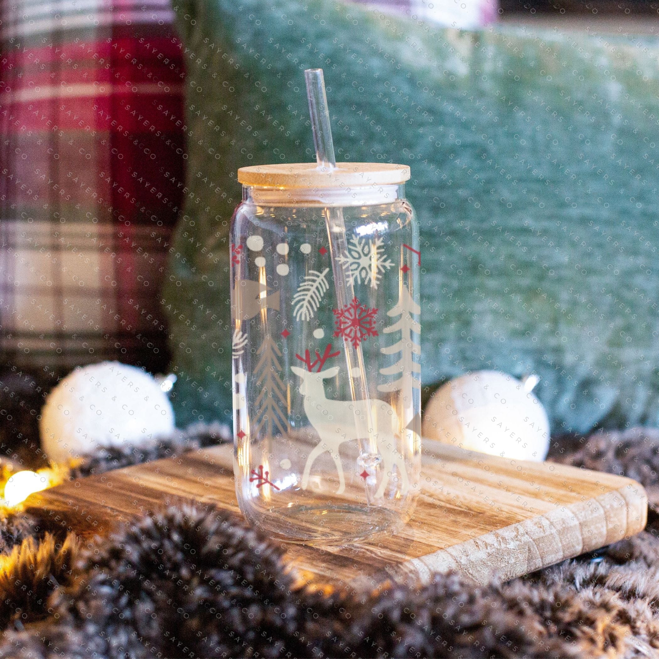 16oz Winter Magic Glass Cup with Bamboo Lid and Straw, featuring winter-themed designs and a clear glass finish.