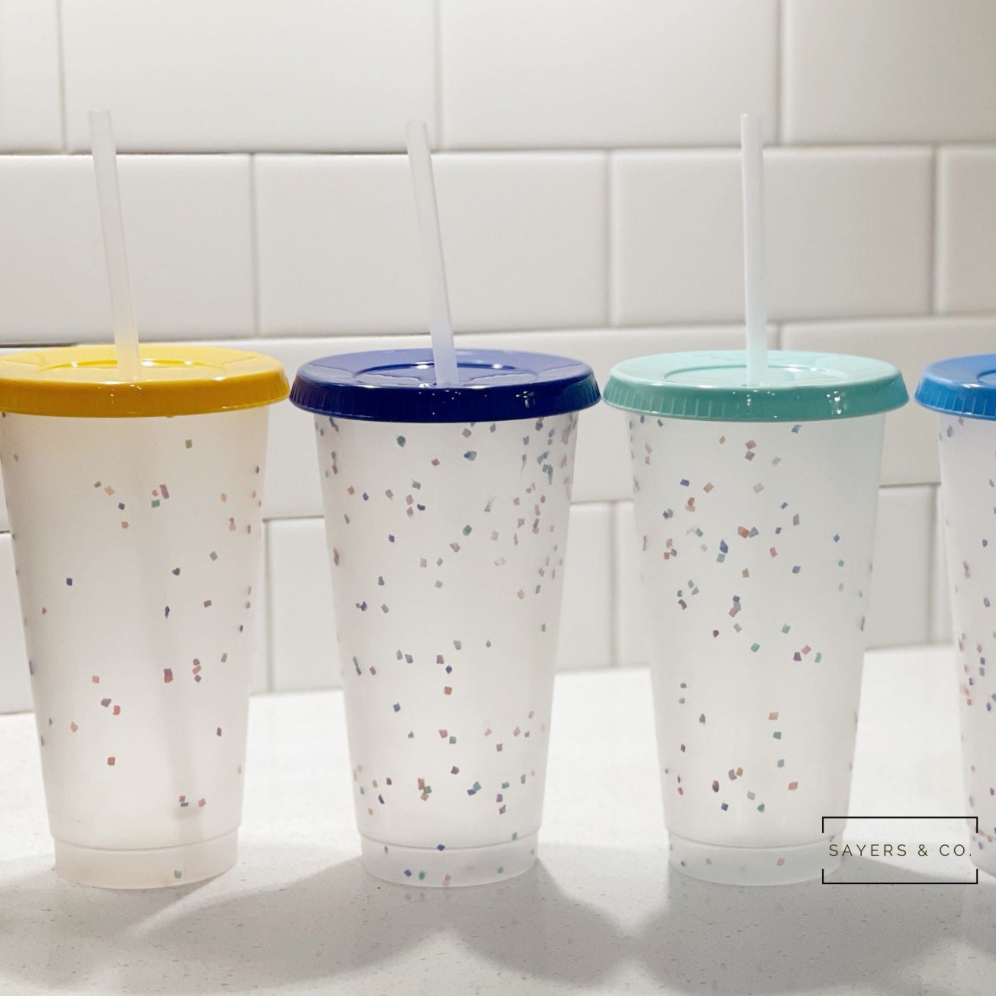 A pack of five 24oz color changing confetti cold cups with straws and lids, showcasing vibrant colors and a fun design.