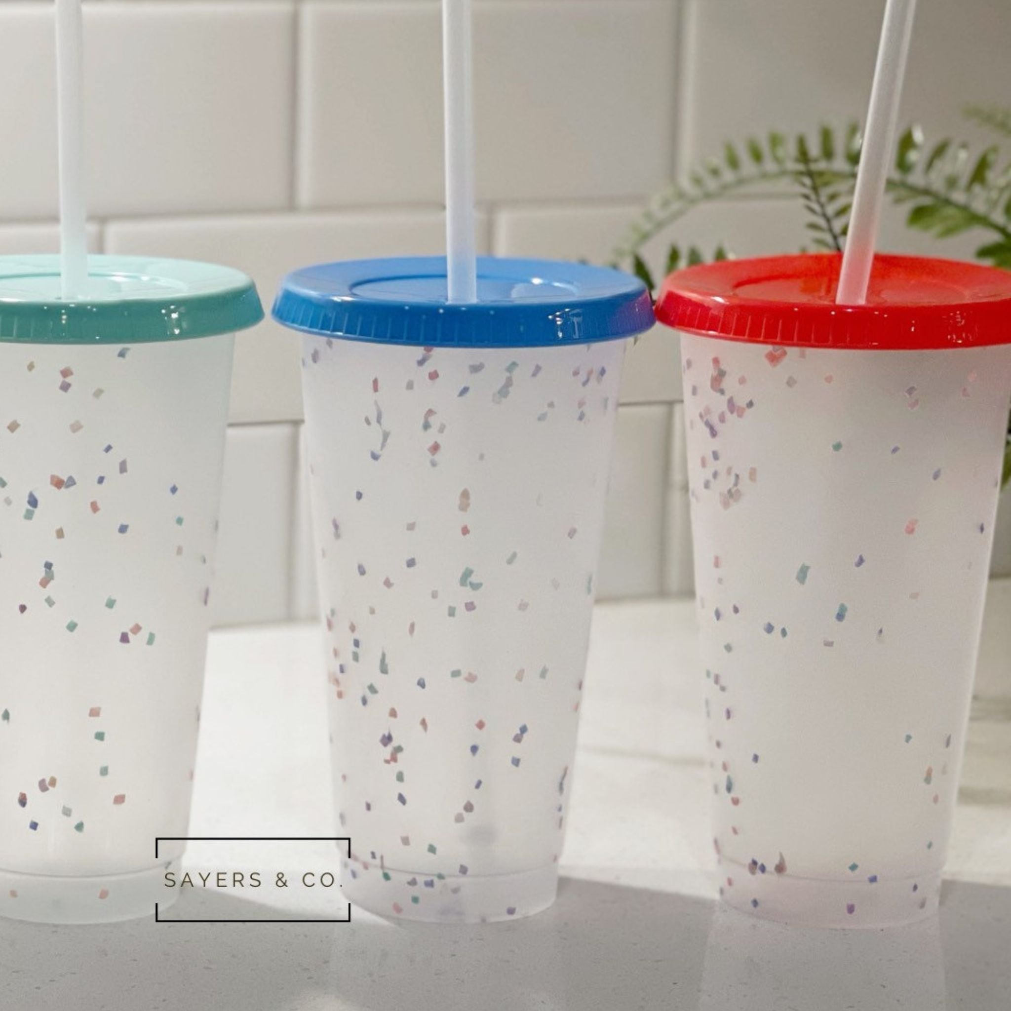 A pack of five 24oz color changing confetti cold cups with straws and lids, showcasing vibrant colors and a fun design.