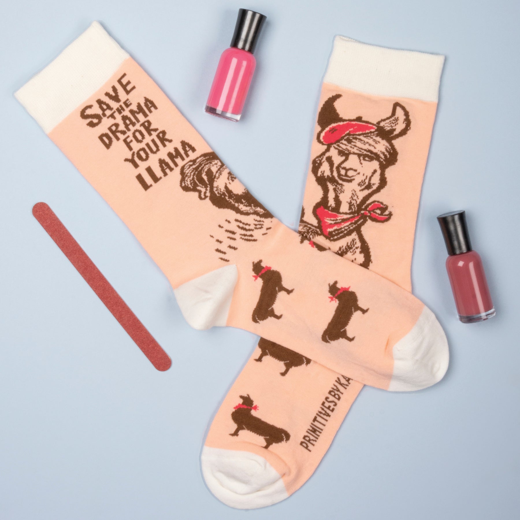 A colorful display of three pairs of animal-themed socks featuring a monkey, llama, and sloth designs, perfect for animal lovers.