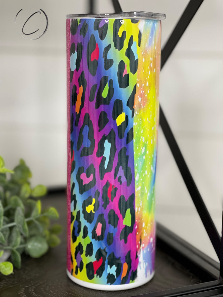 A colorful 20oz skinny tumbler featuring a vibrant 90's art brushstroke design, complete with a reusable straw.