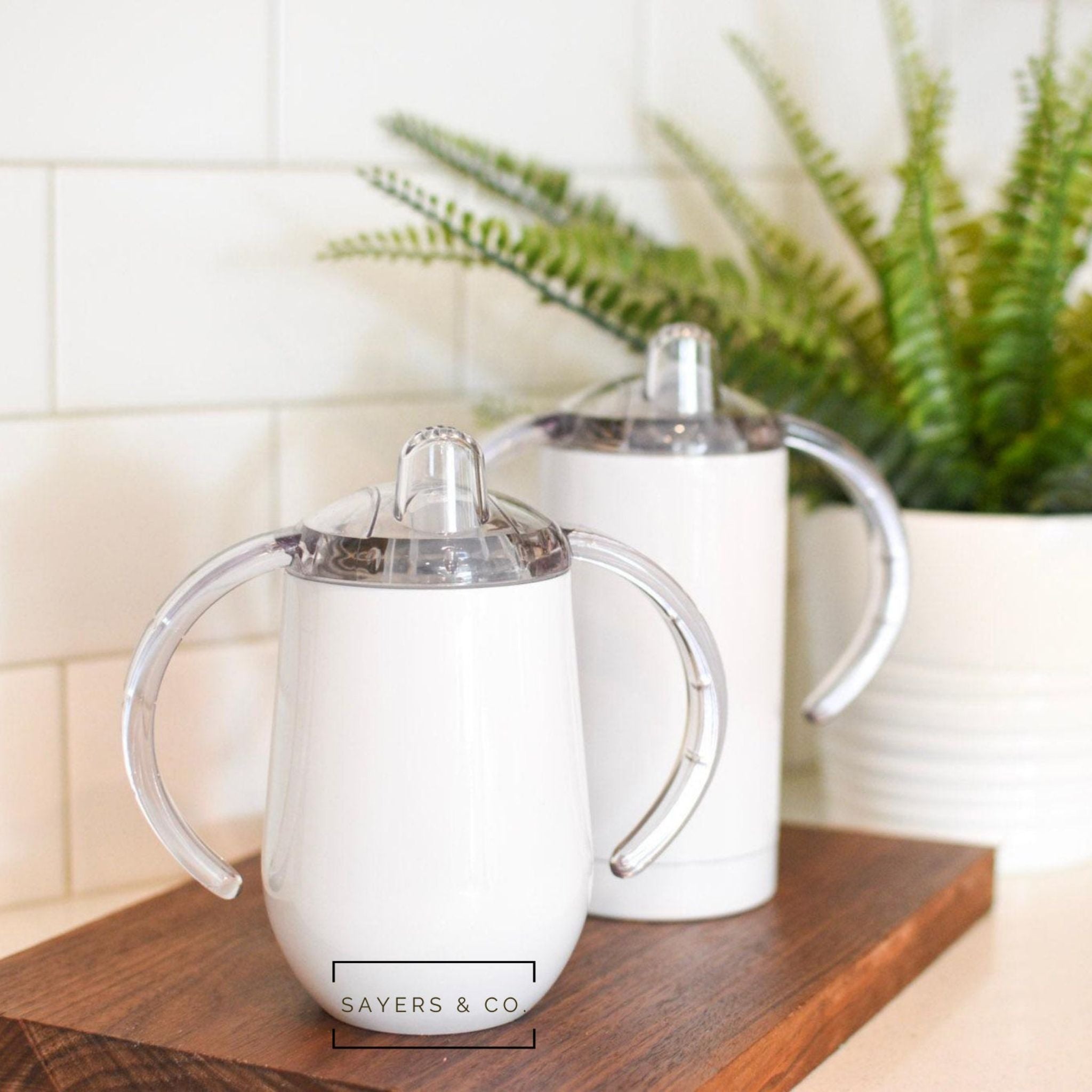 Two white sippy tumblers for sublimation, one 9oz and one 12oz, showcasing their sleek design and leak-proof lids.