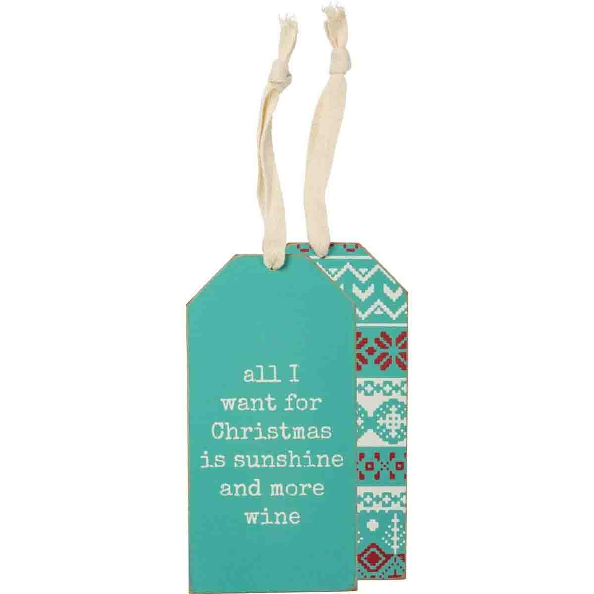 Wooden bottle tag with beach-themed Christmas design, featuring the phrase 'All I Want For Christmas Is Sunshine And More Wine' and a fabric loop.