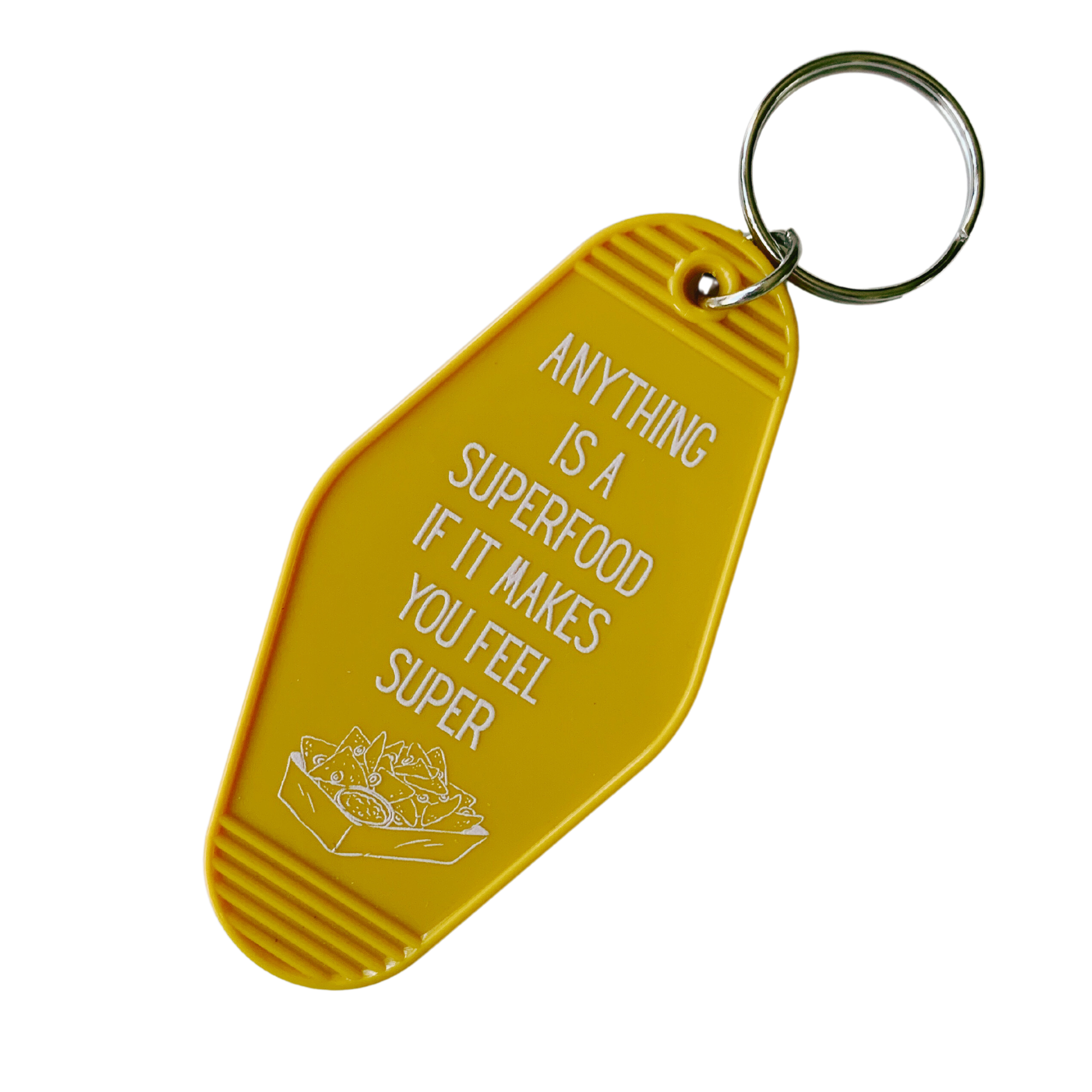 Colorful motel-style keychain with nacho design and text 'ANYTHING IS A SUPERFOOD IF IT MAKES YOU FEEL SUPER'.