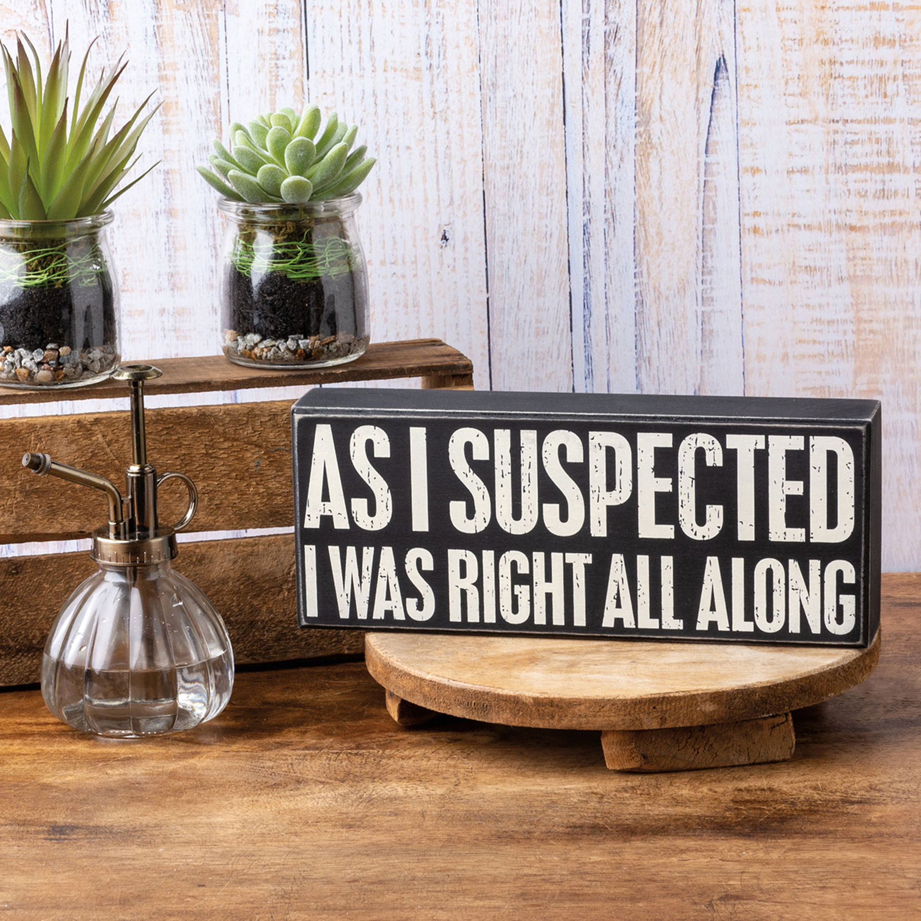 A stylish black and white wooden box sign featuring the quote 'As I Suspected I Was Right All Along' in a distressed finish.