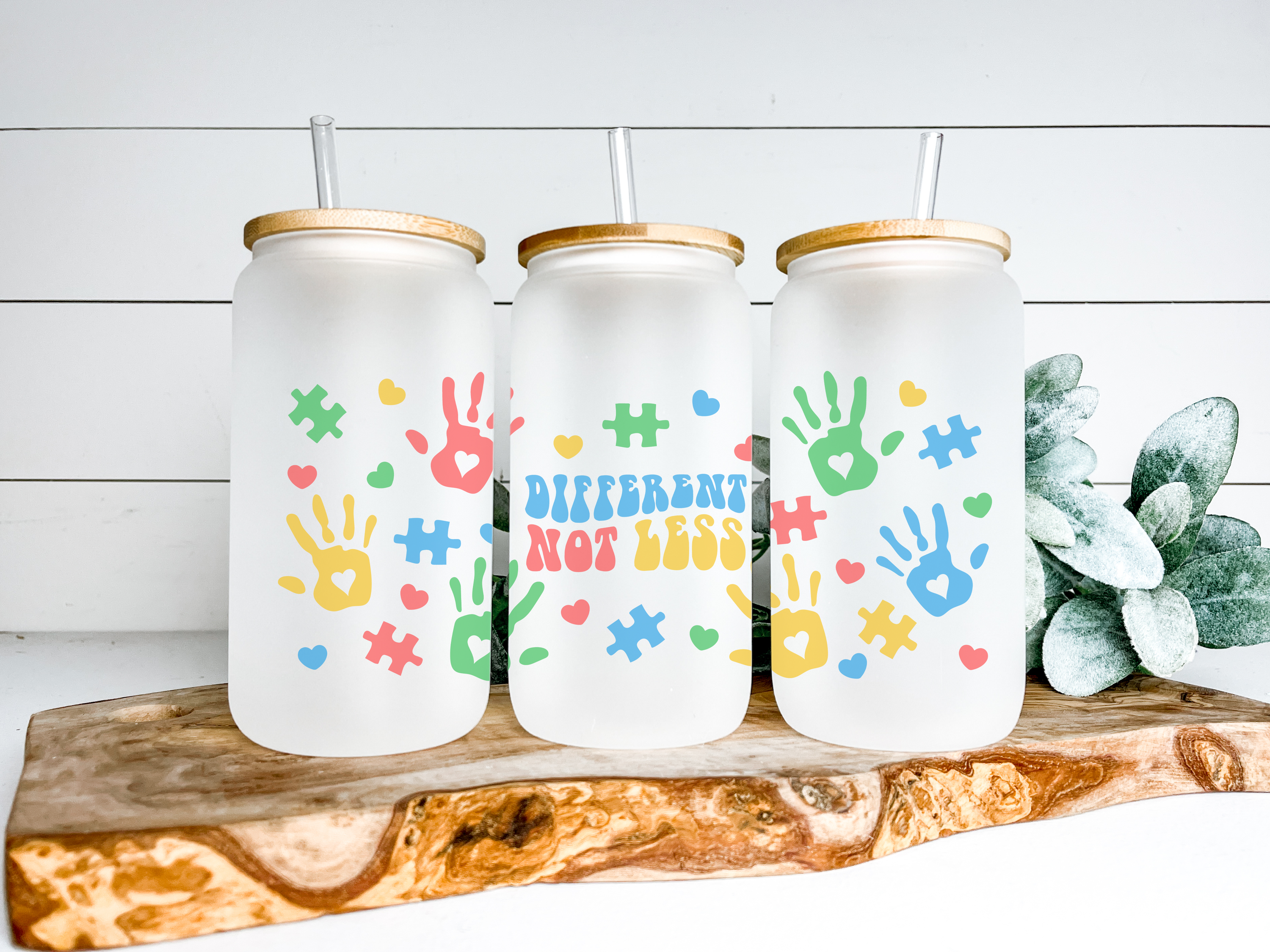 Autism Different Not Less Glass Can Tumbler with bamboo lid and clear straw, showcasing a frosted glass design.