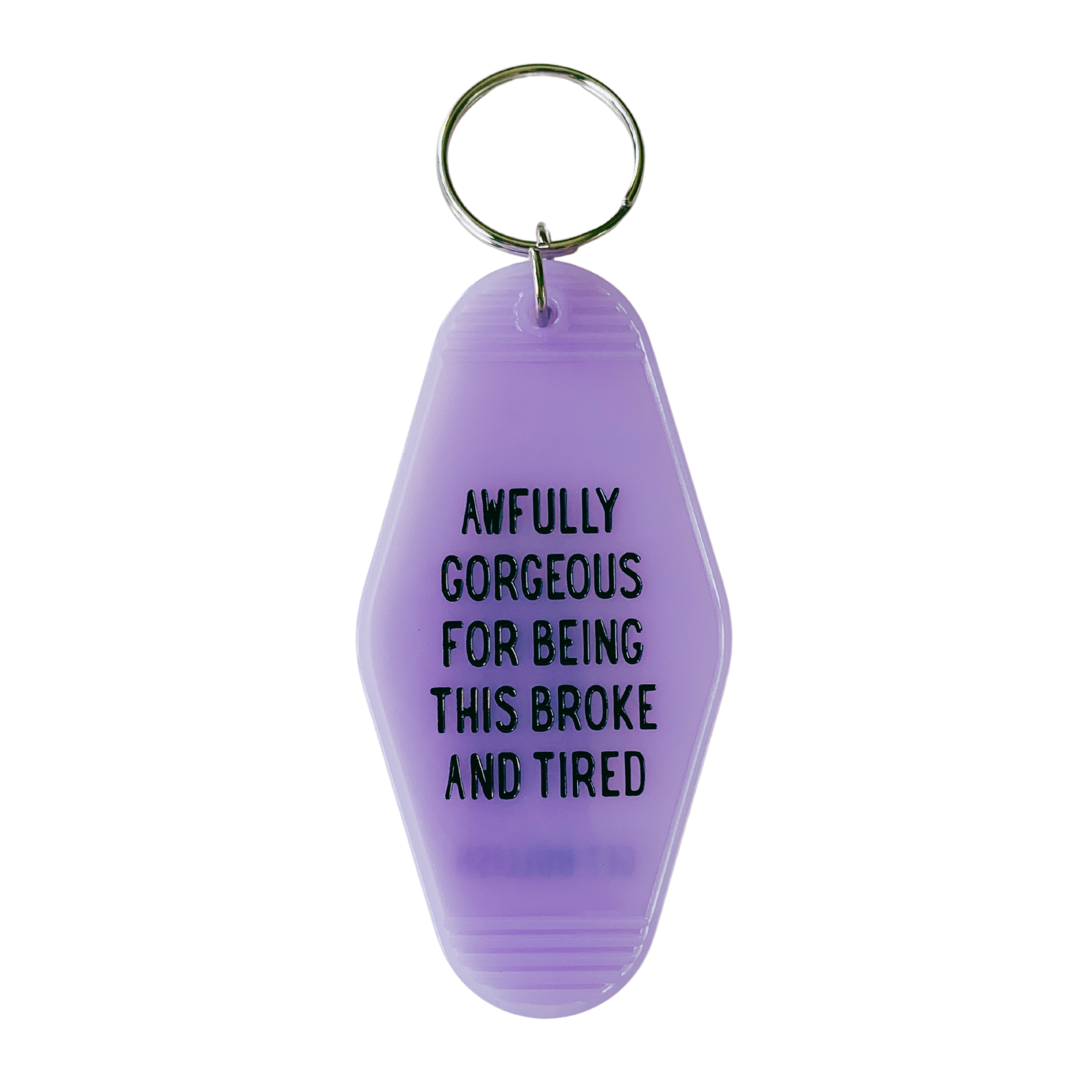 Vibrant purple motel-style keychain with the phrase 'AWFULLY GORGEOUS FOR BEING THIS BROKE AND TIRED' displayed prominently.