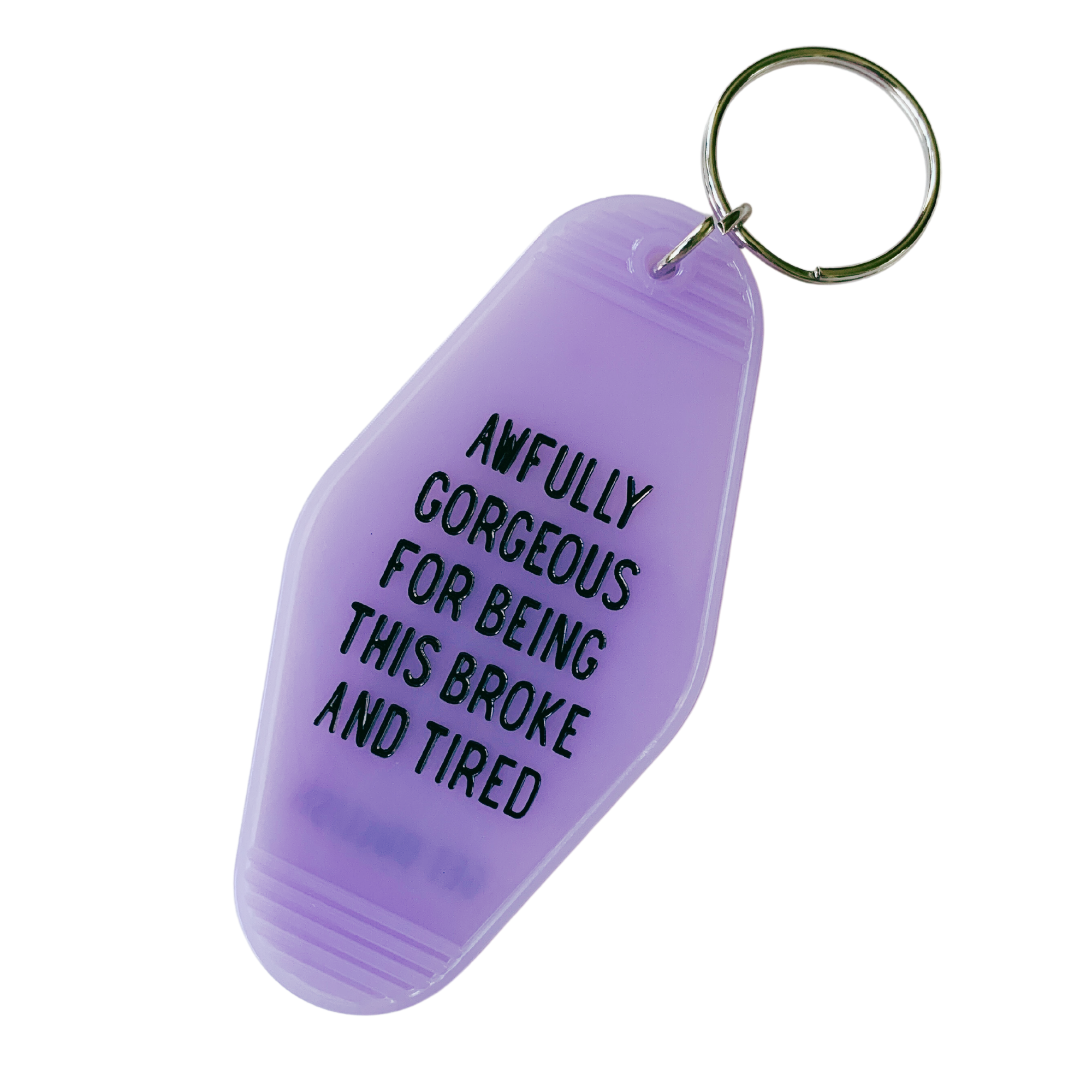 Vibrant purple motel-style keychain with the phrase 'AWFULLY GORGEOUS FOR BEING THIS BROKE AND TIRED' displayed prominently.