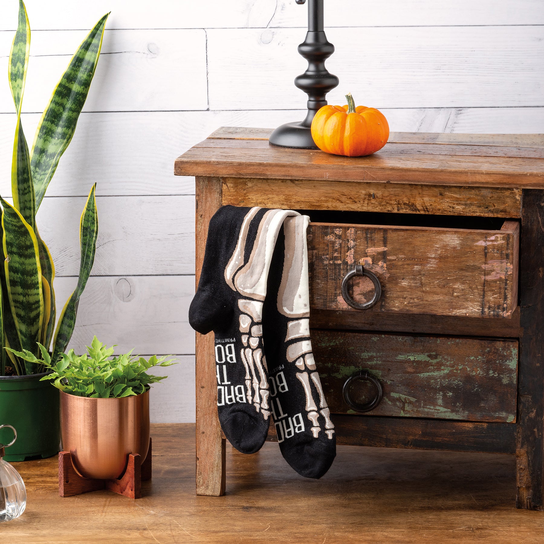 Colorful Bad To The Bone socks featuring woven skeleton leg designs and hand lettered text.