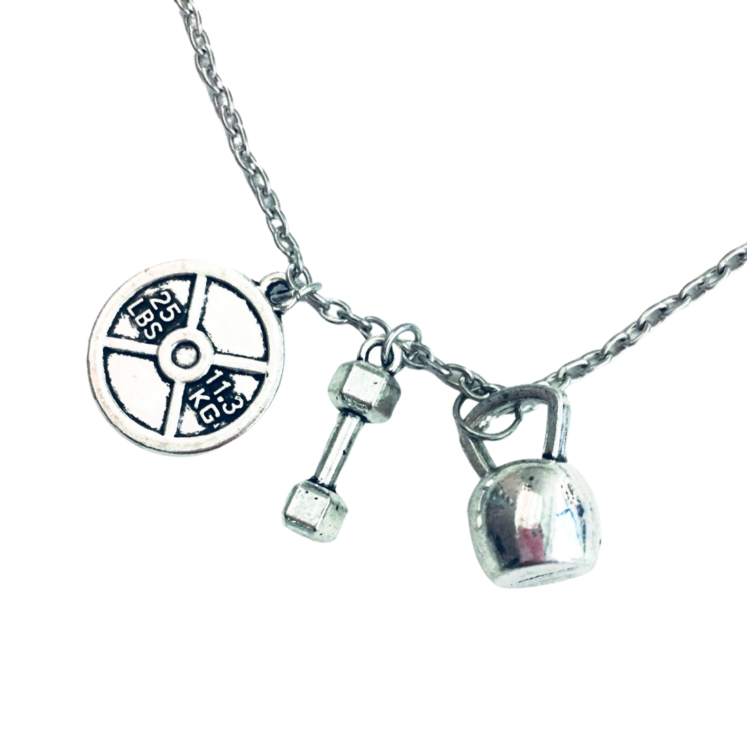 Badass Weightlifter Triple Charm Necklace in Silvertone featuring kettlebell, dumbbell, and weight plate charms.