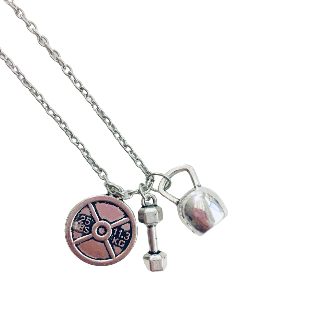 Badass Weightlifter Triple Charm Necklace in Silvertone featuring kettlebell, dumbbell, and weight plate charms.
