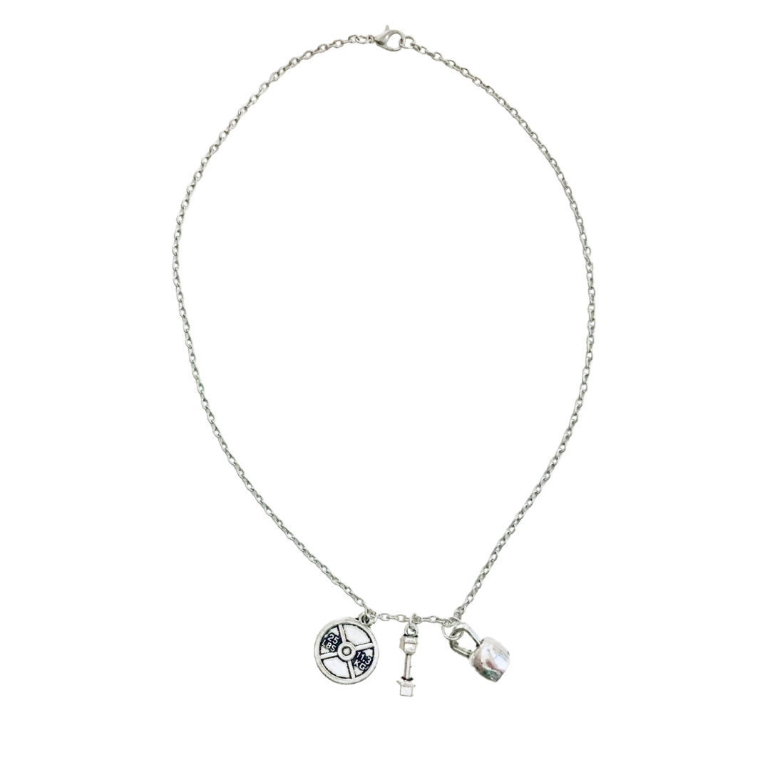 Badass Weightlifter Triple Charm Necklace in Silvertone featuring kettlebell, dumbbell, and weight plate charms.