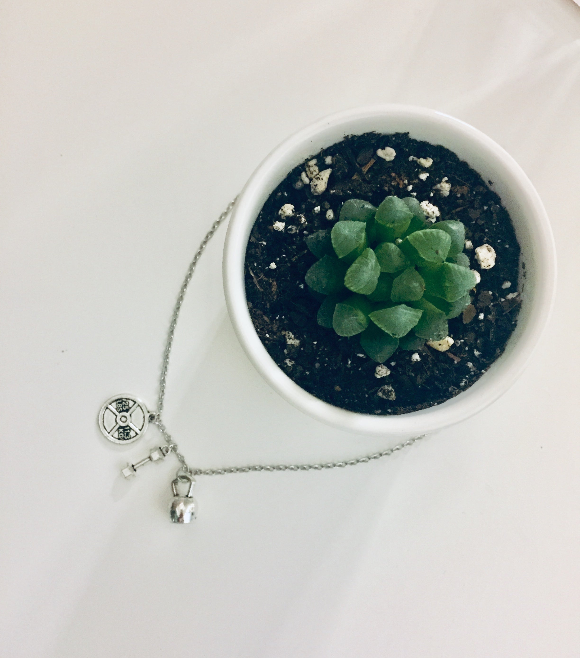 Badass Weightlifter Triple Charm Necklace in Silvertone featuring kettlebell, dumbbell, and weight plate charms.