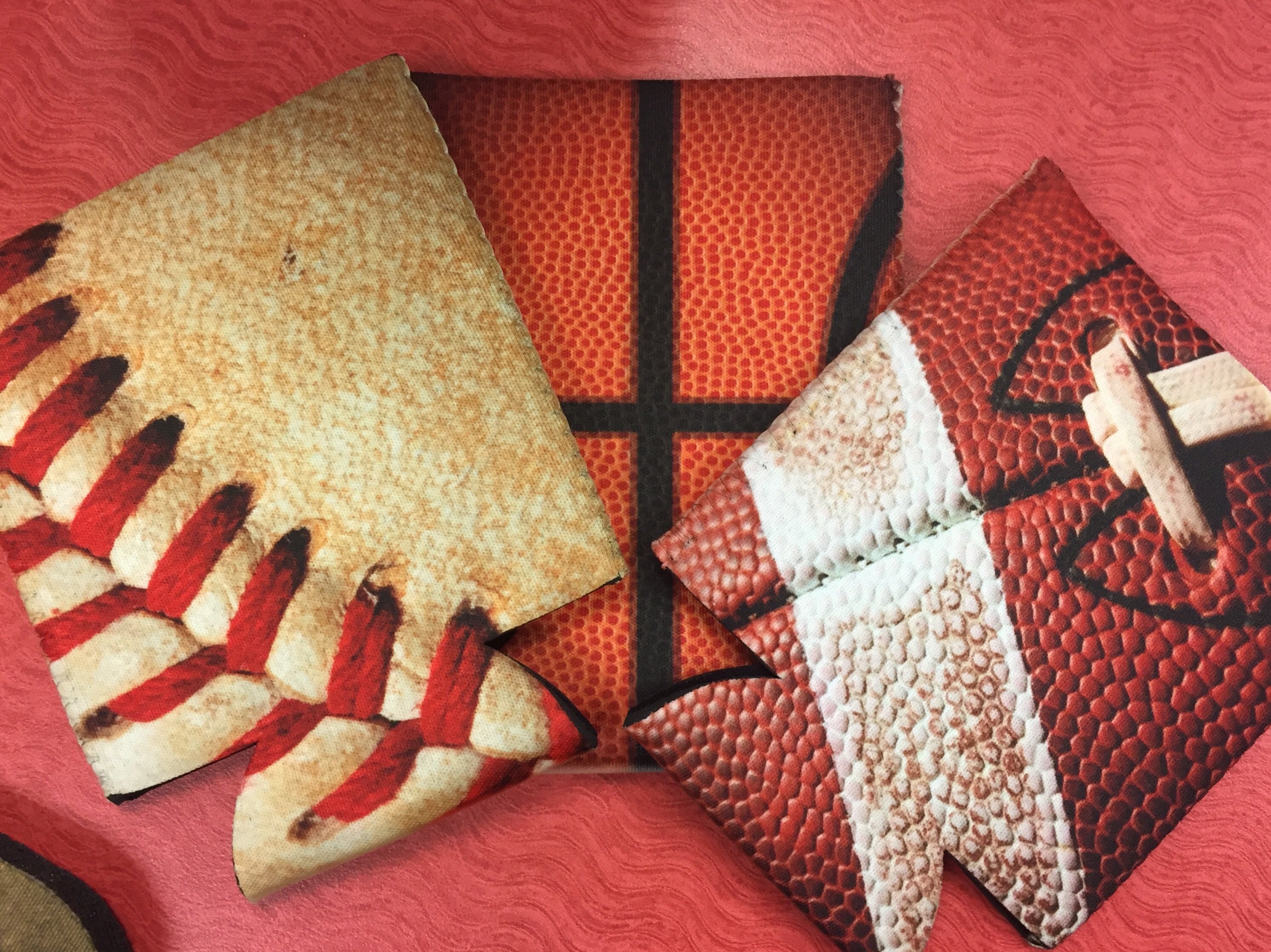 Ballin’ Sports Beverage Holder featuring neoprene insulation in basketball, baseball, and football designs, perfect for keeping drinks cold.