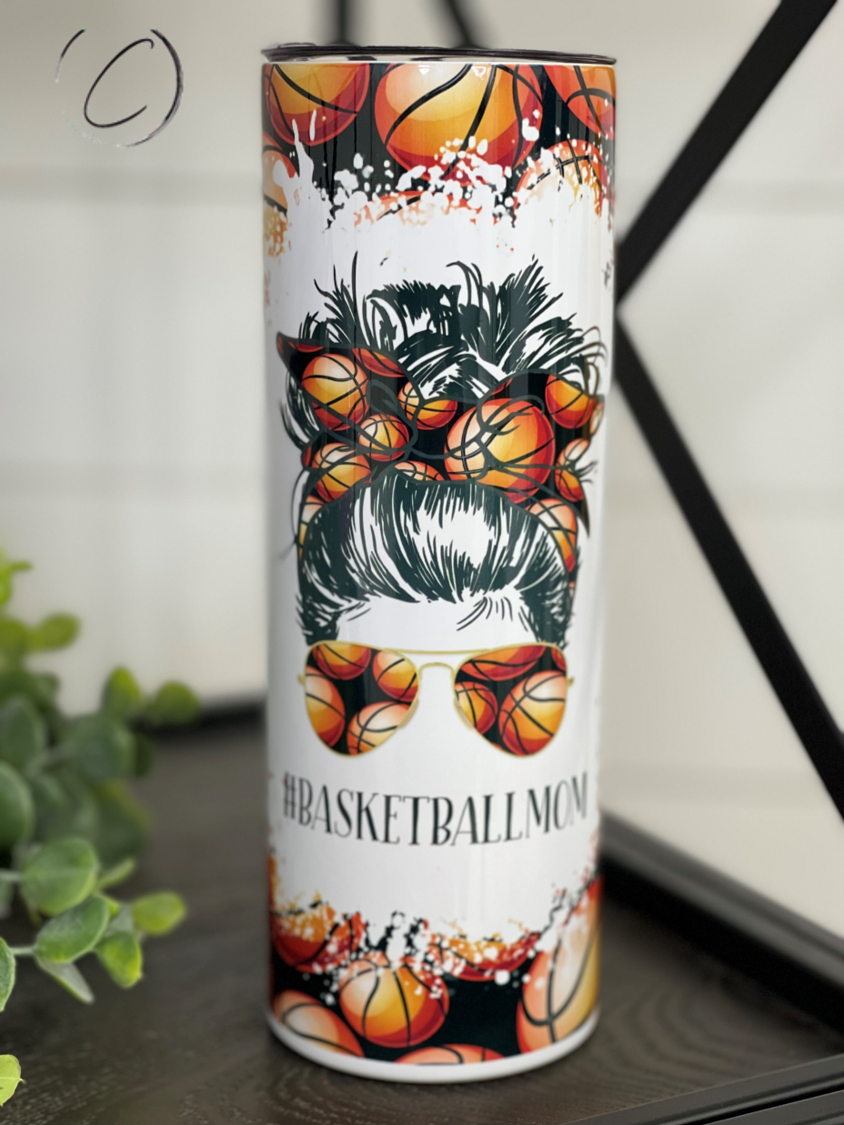 A stylish 20oz skinny tumbler featuring a full wrap design with '#Basketballmom' text, perfect for on-the-go hydration.
