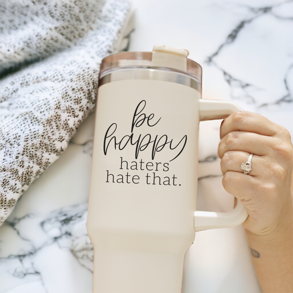 Be Happy 40oz insulated mug with handle, lid, and straw, featuring a matte cream finish and black graphic design.