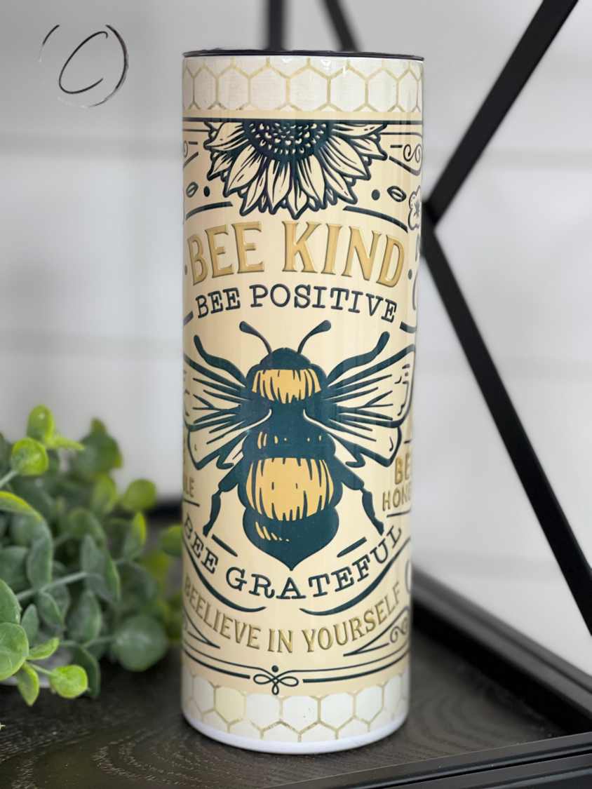 Bee Kind 20oz Skinny Tumbler with a vibrant full wrap design, featuring a reusable straw and durable construction.