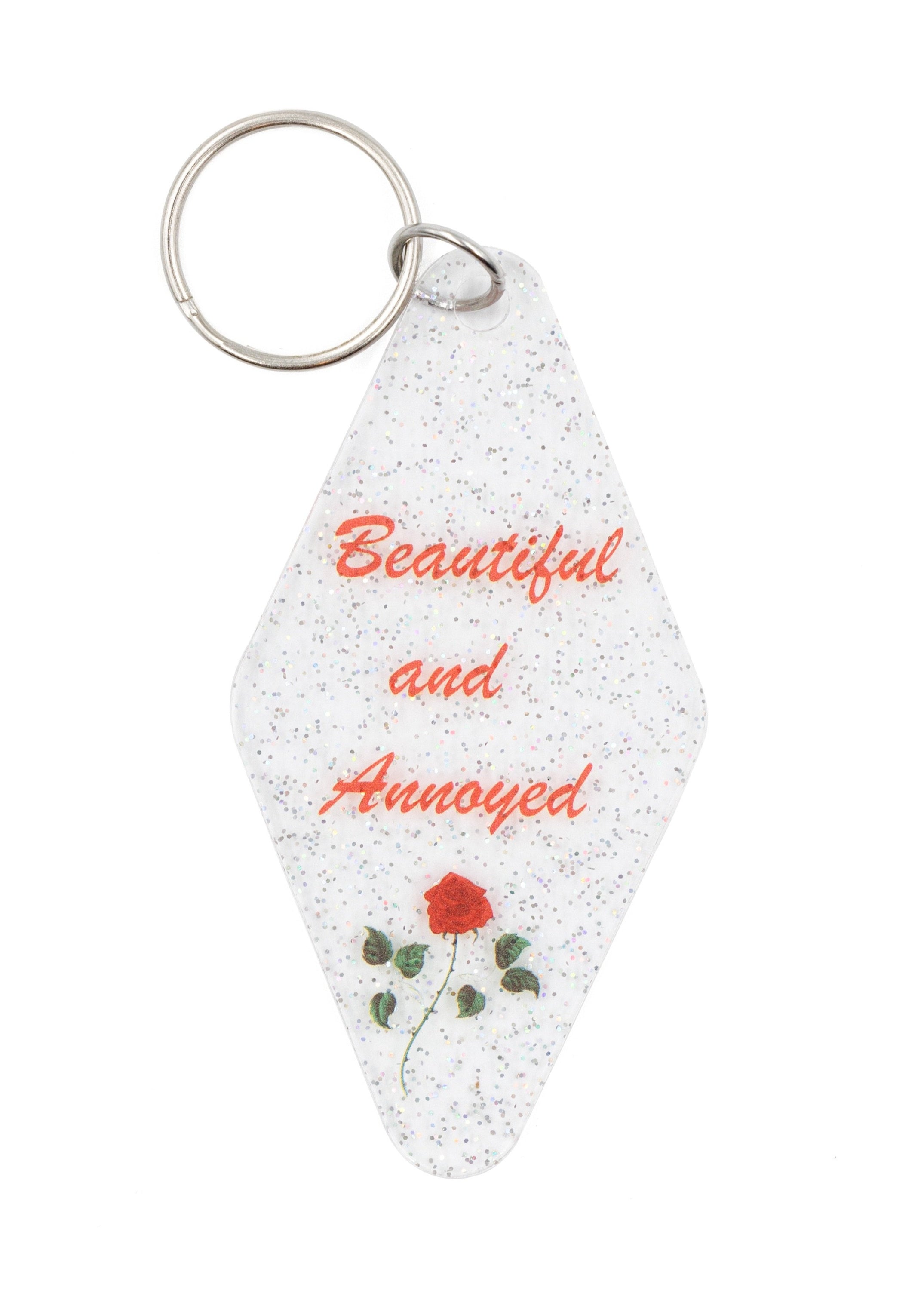 Beautiful and Annoyed Motel Style Key Tag Keychain with clear glitter design, featuring the phrase 'Beautiful and Annoyed' in bold letters.