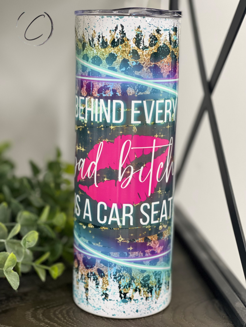 Behind Every Bad B**** 20oz Skinny Tumbler with a stylish design and reusable straw, perfect for hot and cold beverages.