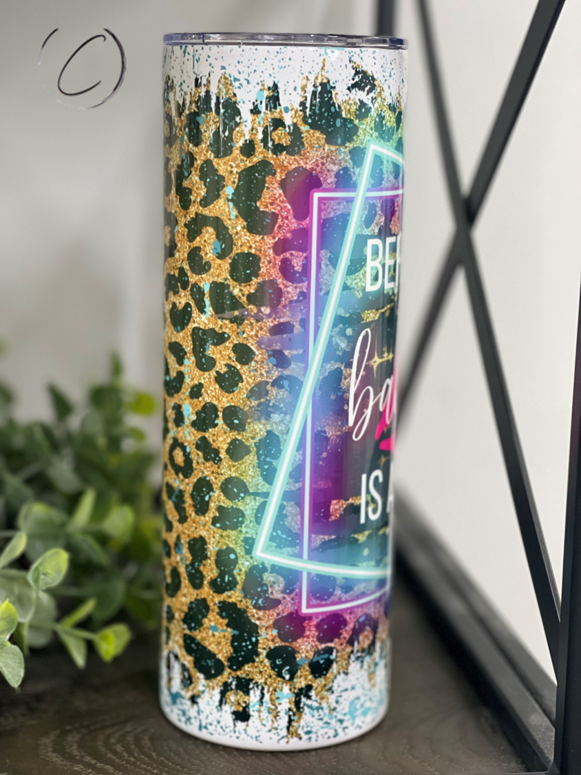 Behind Every Bad B**** 20oz Skinny Tumbler with a stylish design and reusable straw, perfect for hot and cold beverages.