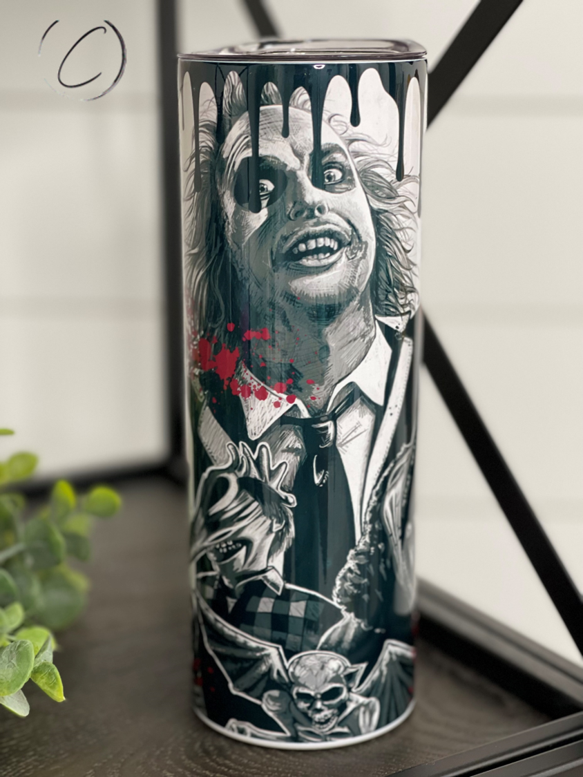 Beetlejuice 20oz Skinny Tumbler featuring a vibrant full wrap design, complete with a reusable straw.