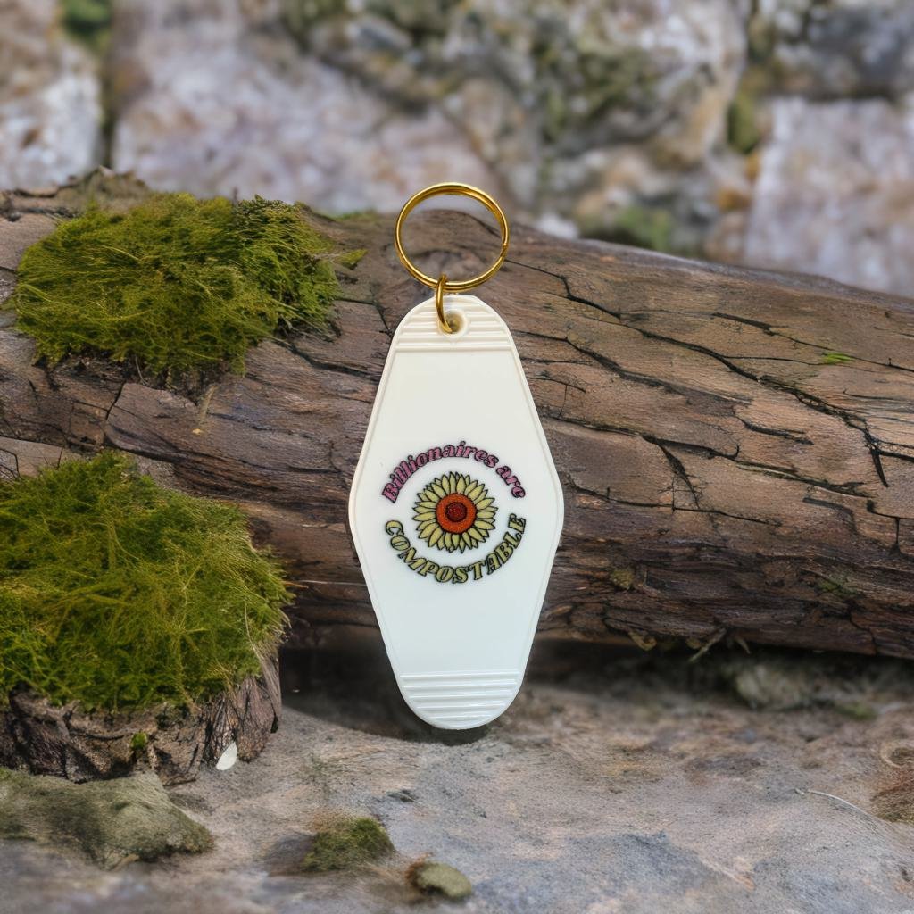 Billionaires Are Compostable motel-style keychain featuring bold text and a classic design, perfect for expressing anti-plutocracy sentiments.