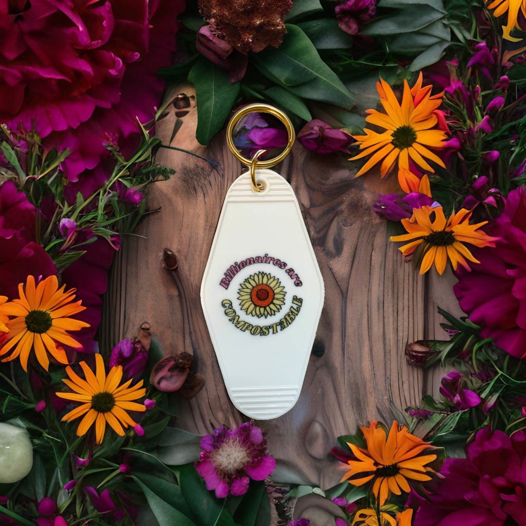 Billionaires Are Compostable motel-style keychain featuring bold text and a classic design, perfect for expressing anti-plutocracy sentiments.