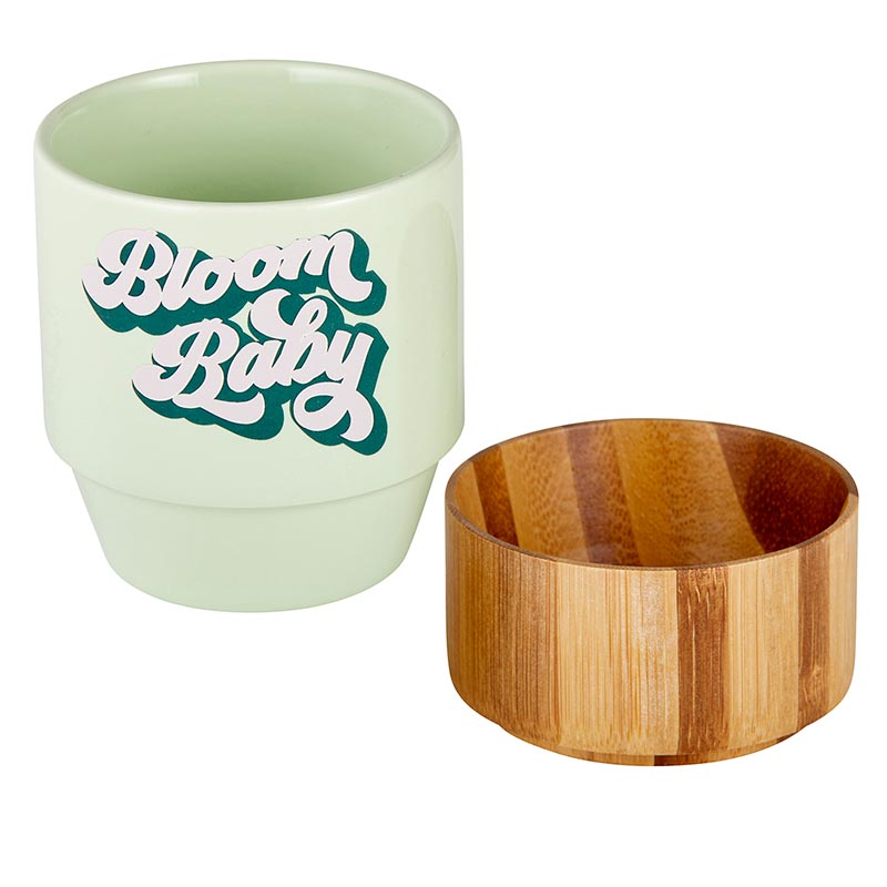 Bloom Baby Petite Ceramic Mug in light green with bamboo base, perfect for tea or snacks.