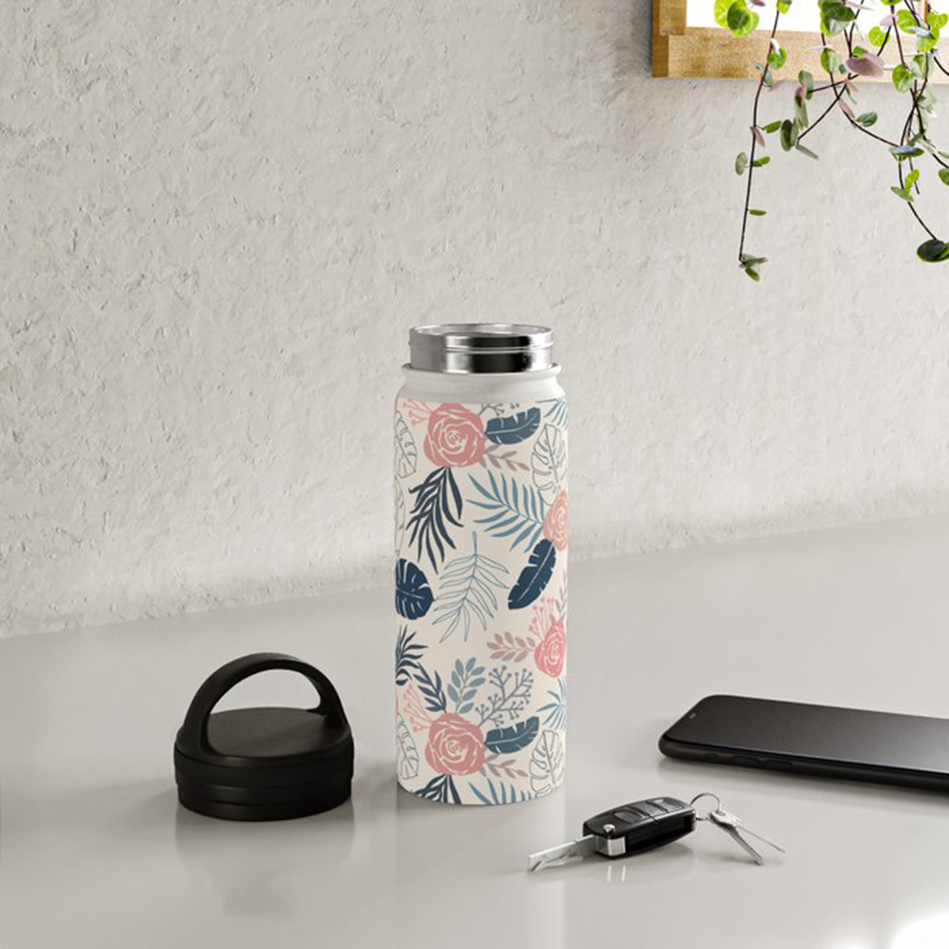 Blue and blush tropical floral stainless steel water bottle with a handle lid, showcasing its vibrant design and durable construction.