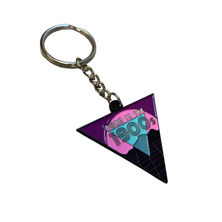 Born in the 1900s enamel keychain featuring vibrant colors and retro design, attached to a split ring.