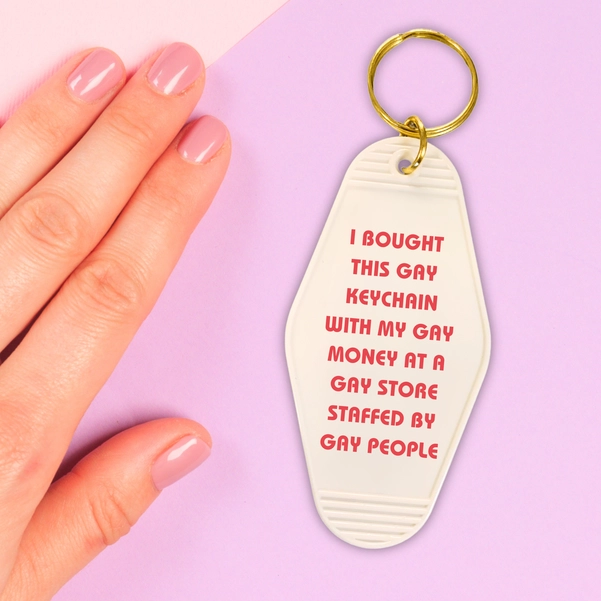 Colorful motel style keychain with the phrase 'ALL I WANT IS PERFECT SKIN AND FREE MONEY' on a split ring.